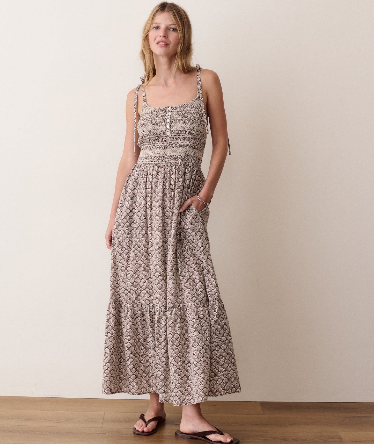 Brown smocked dress on a hanger in store
