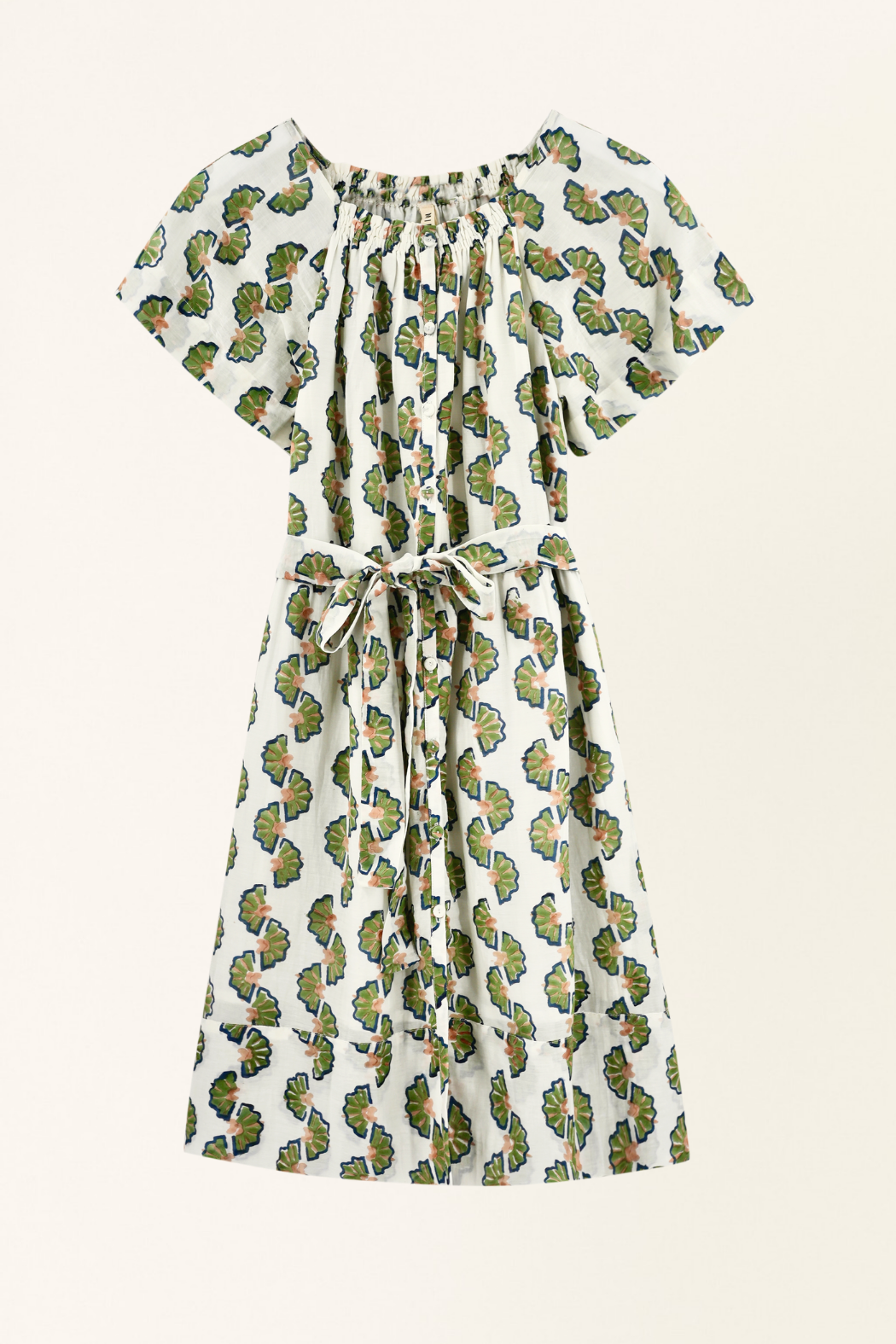 Green cotton short dress on a hanger in store