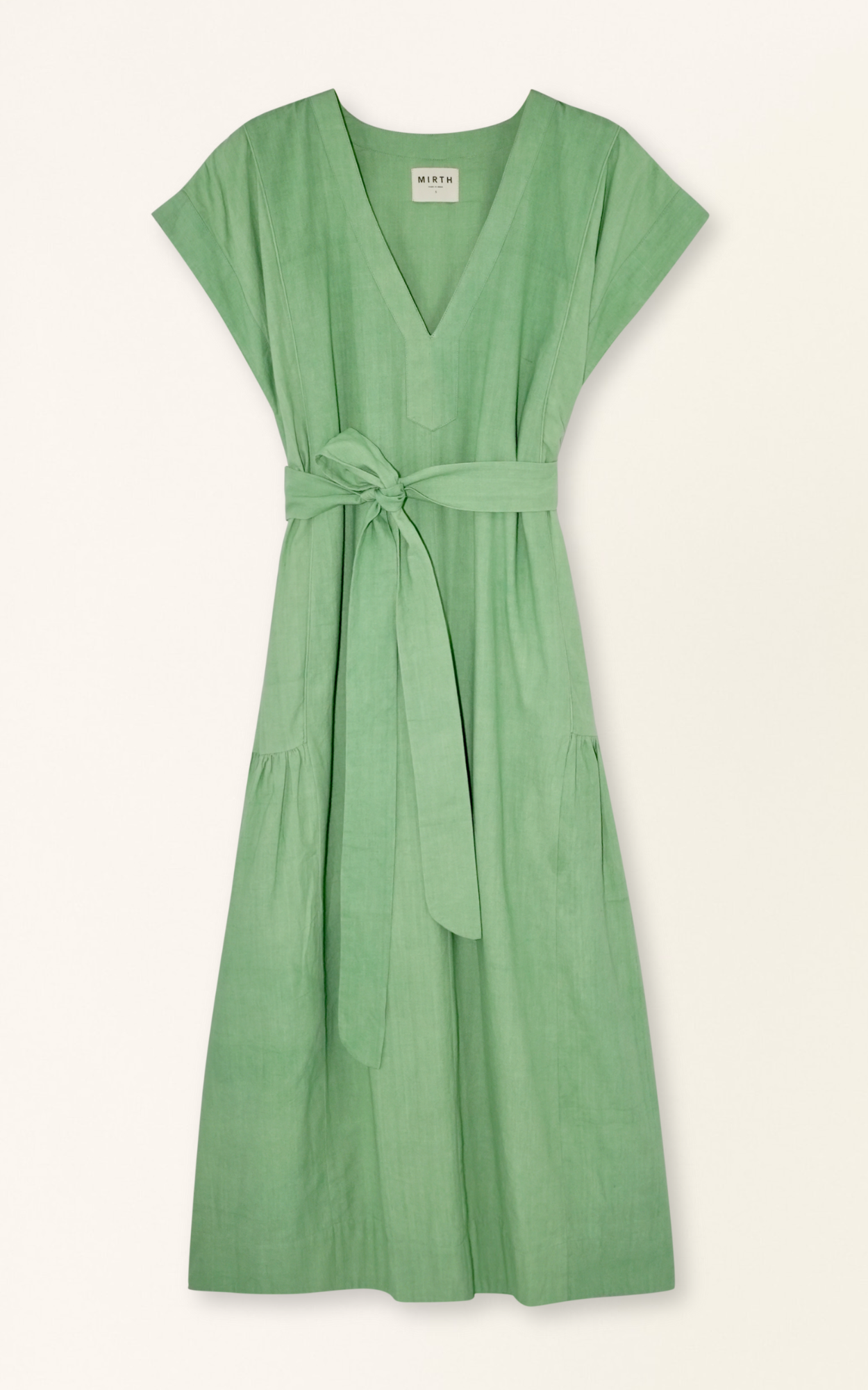 Green cotton midi dress on a hanger in store