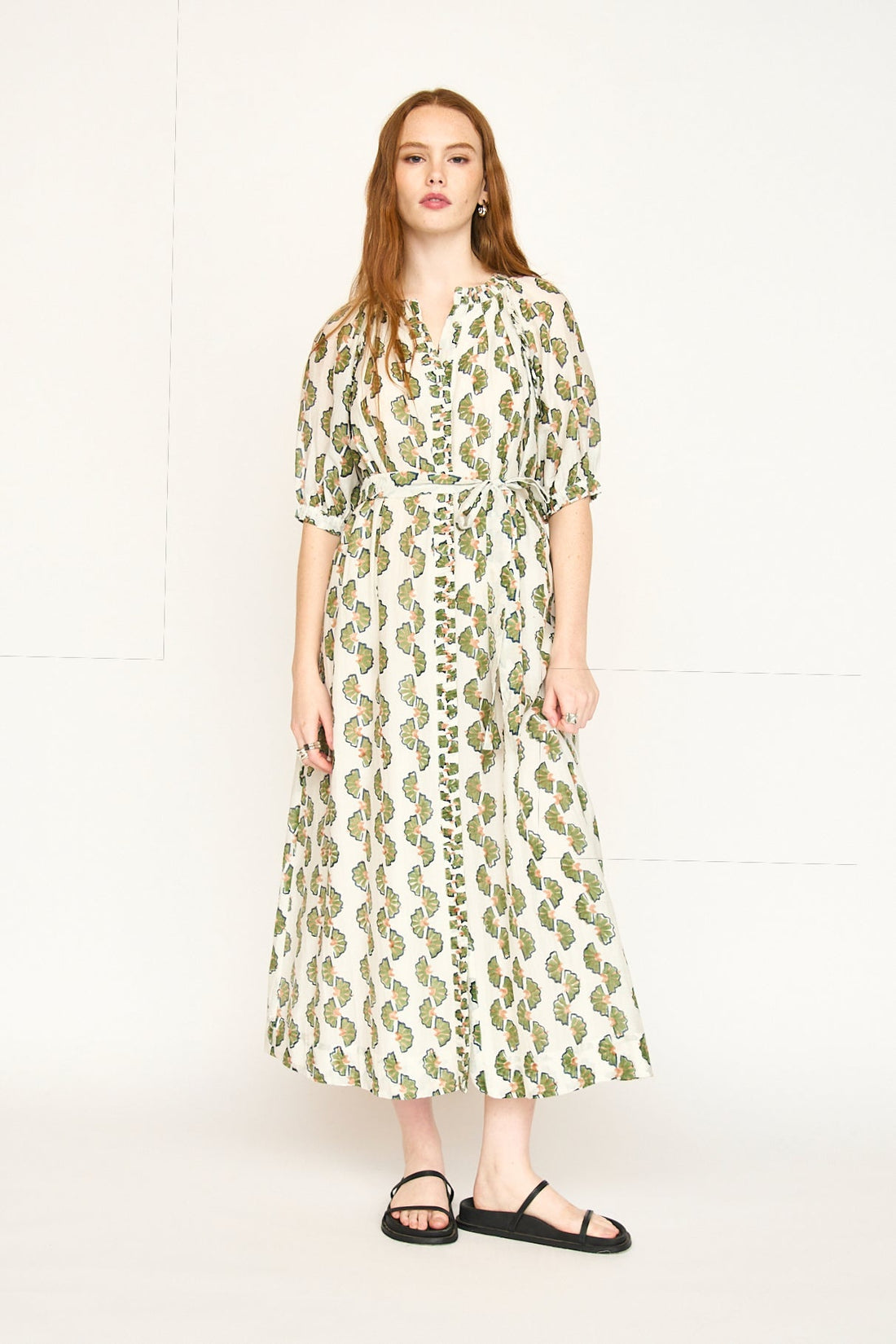 Green cotton maxi dress on a hanger in store
