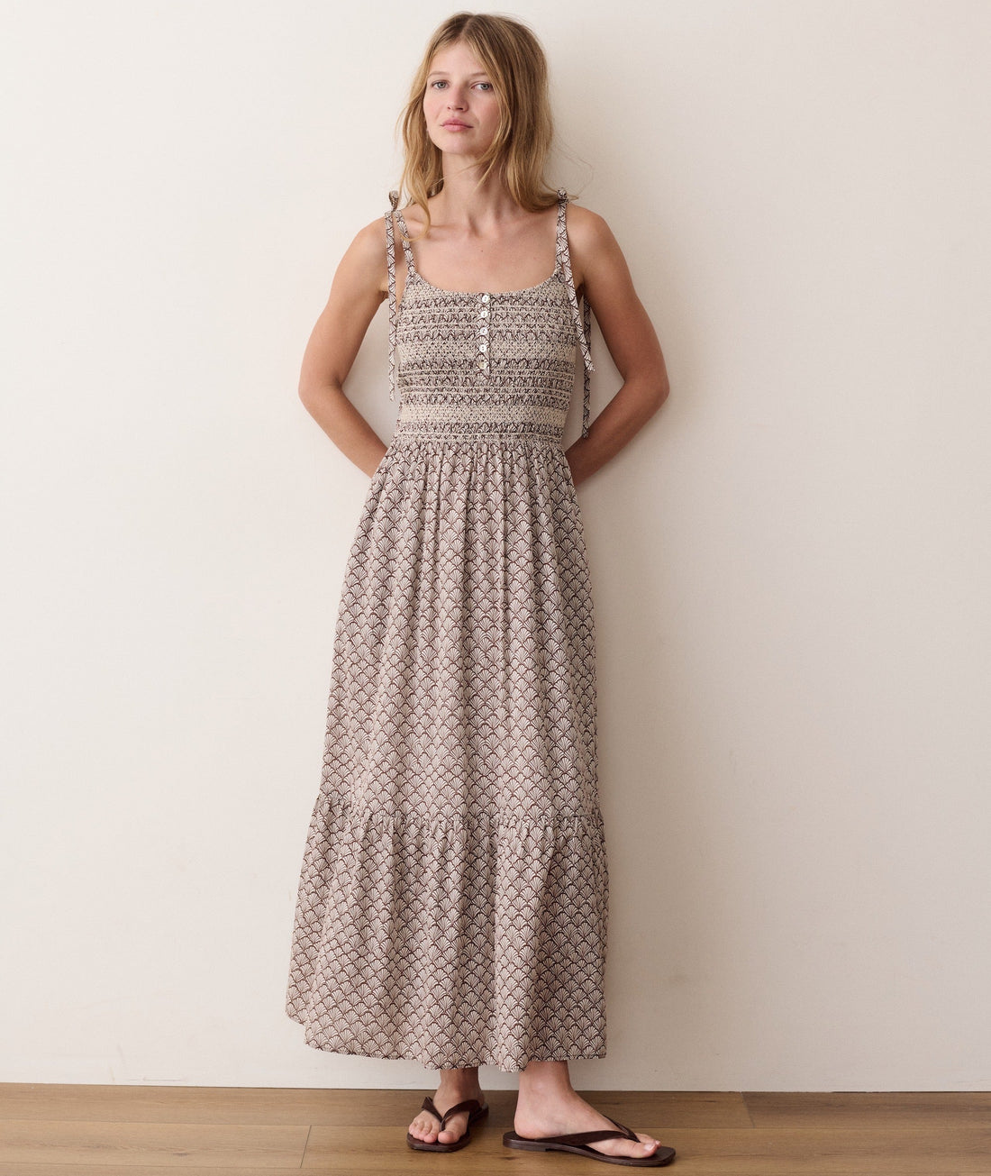 Brown smocked dress on a hanger in store