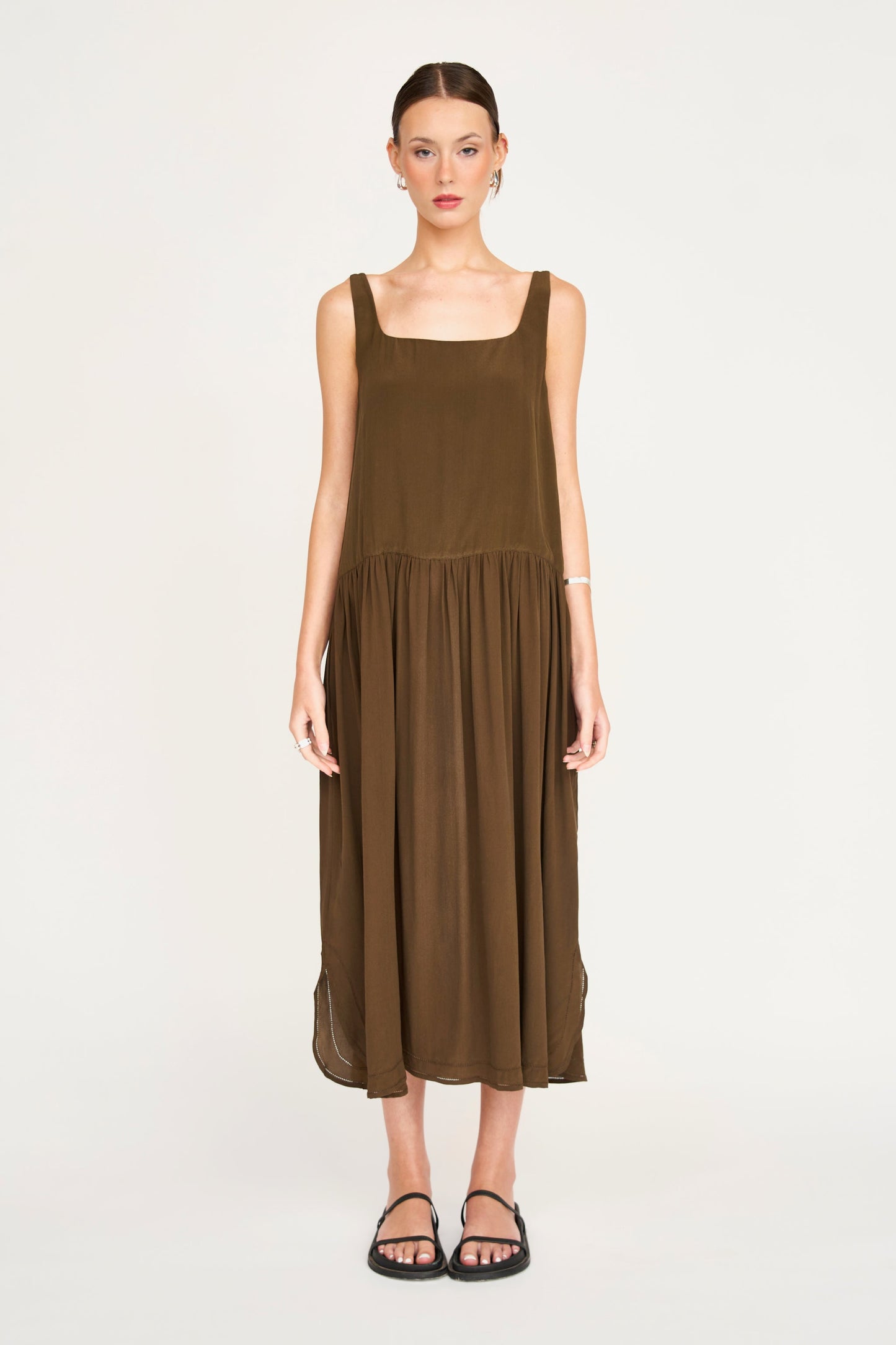 Brown silk midi dress on a hanger in store