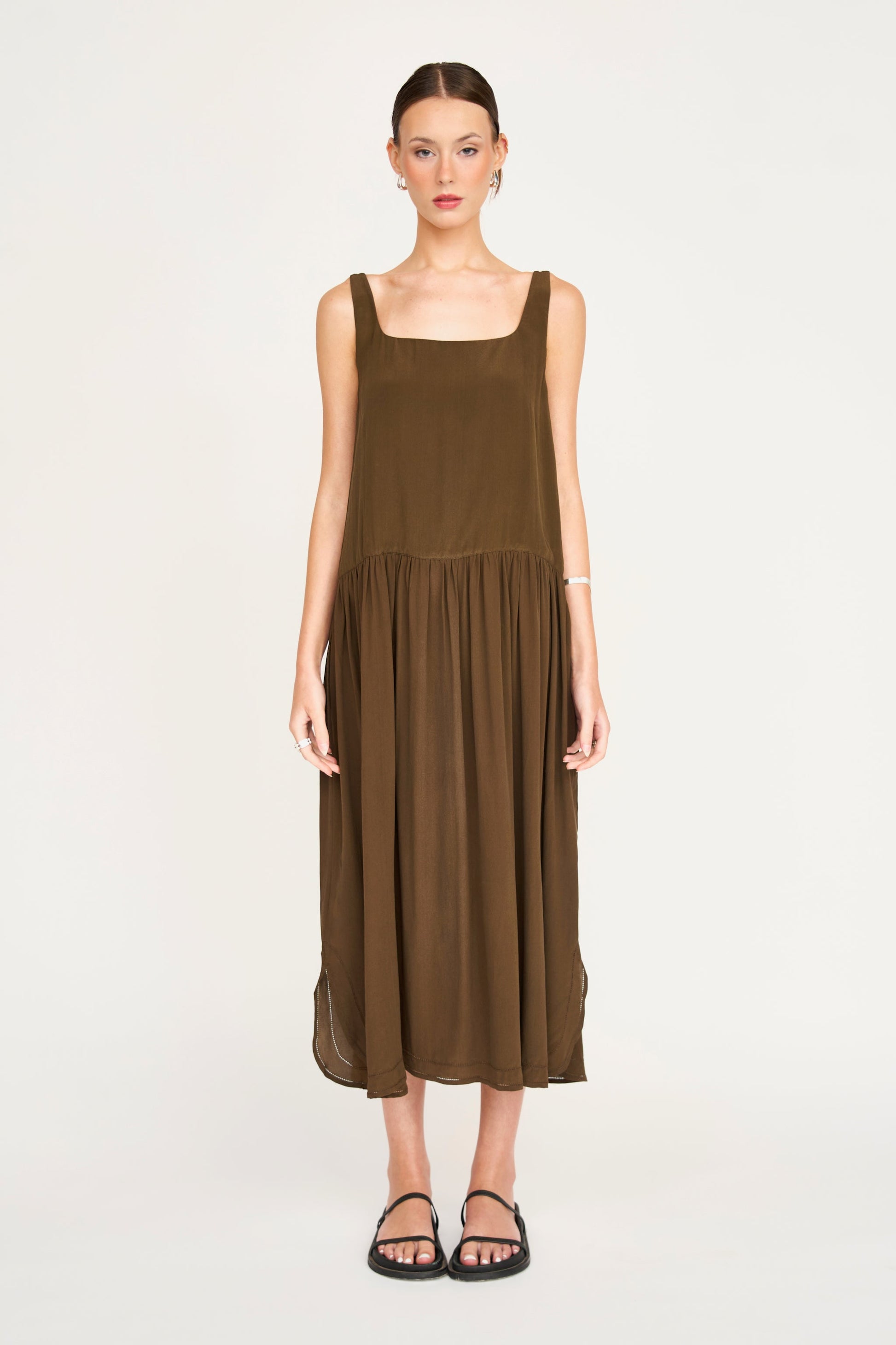 Brown silk midi dress on a hanger in store