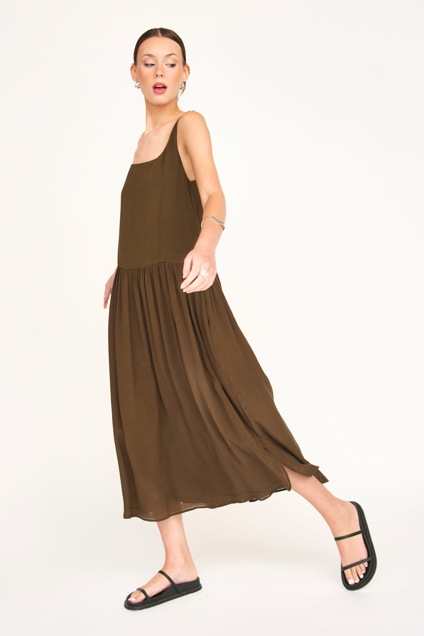 Brown silk midi dress on a hanger in store