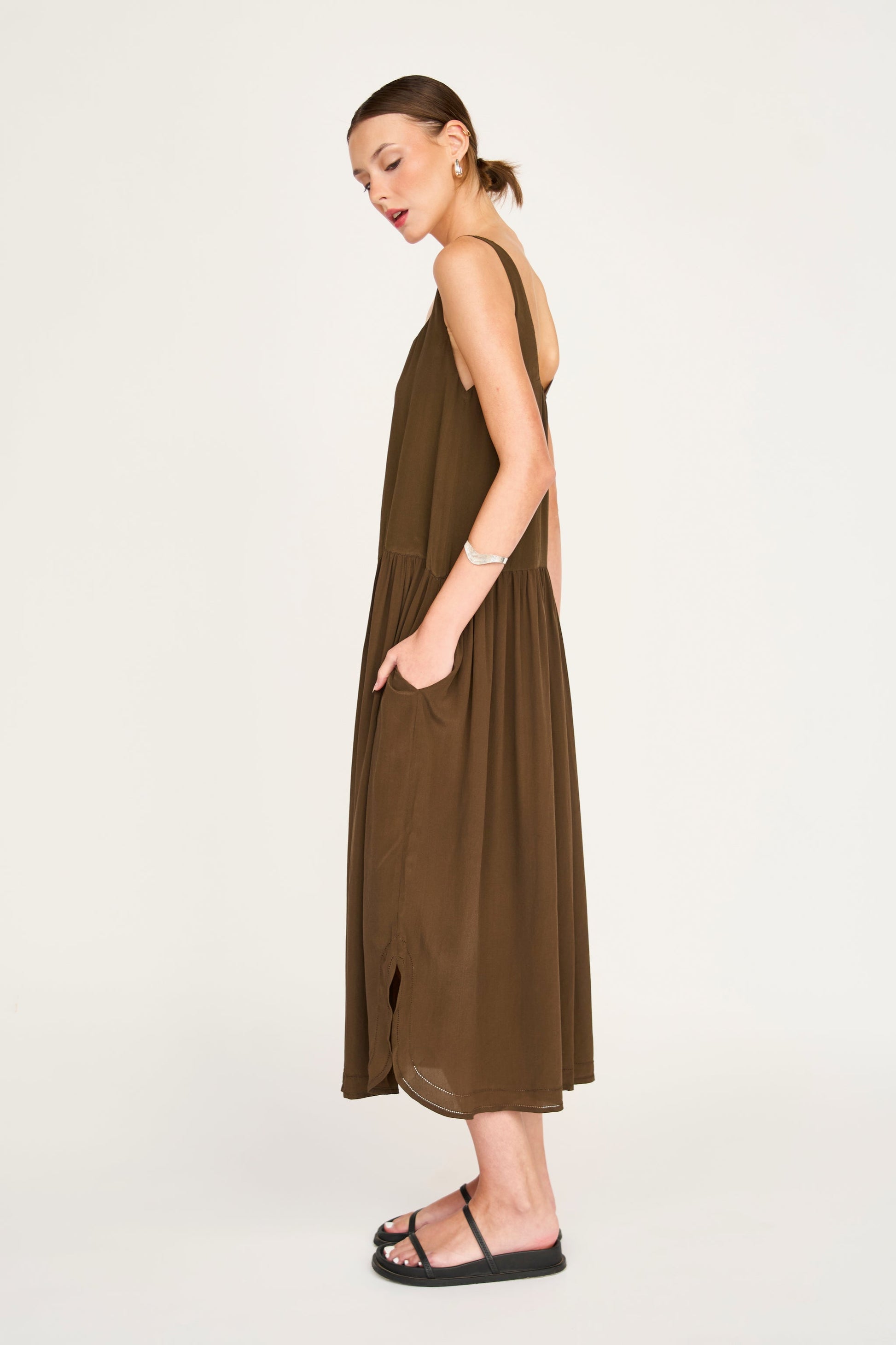 Brown silk midi dress on a hanger in store