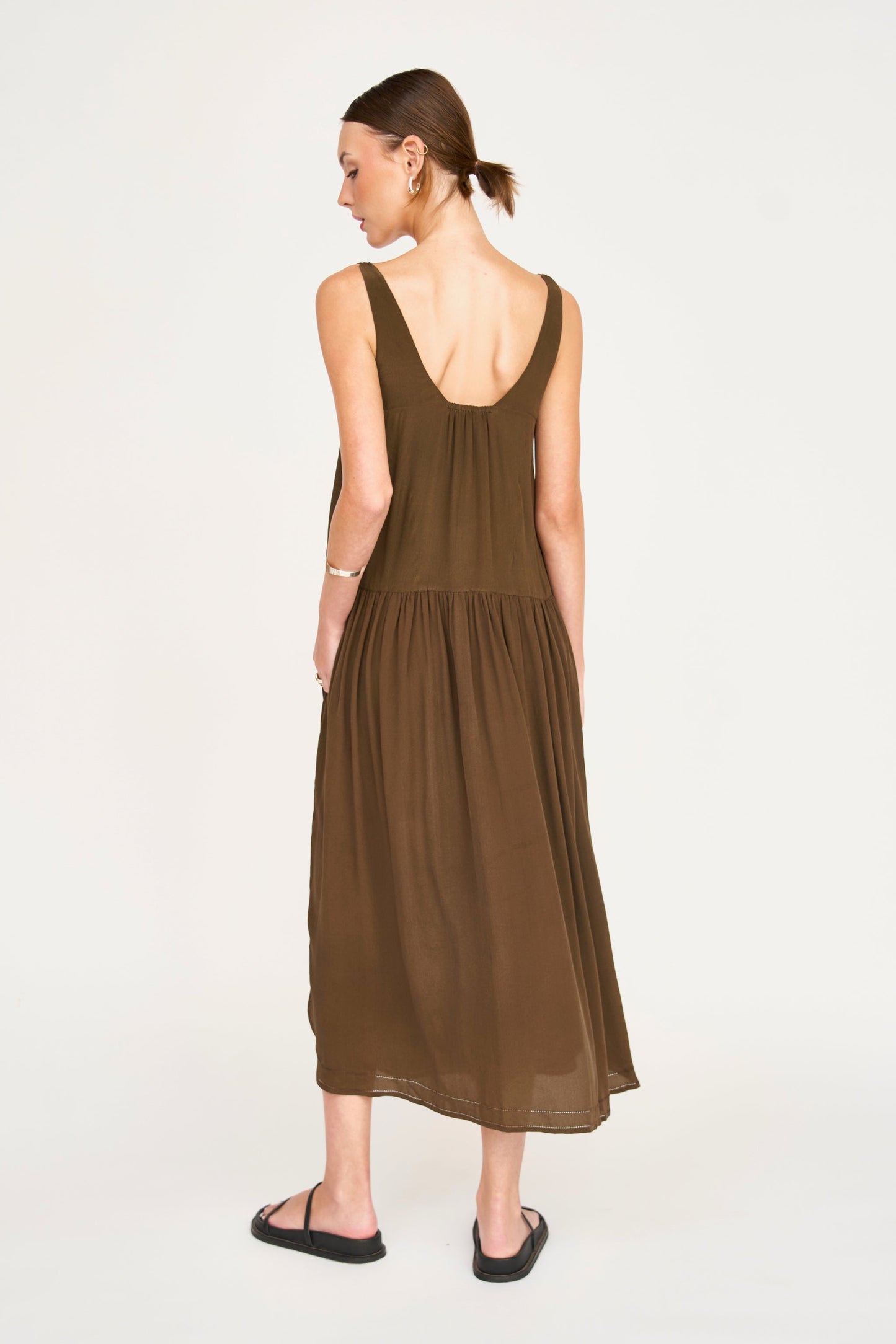 Brown silk midi dress on a hanger in store