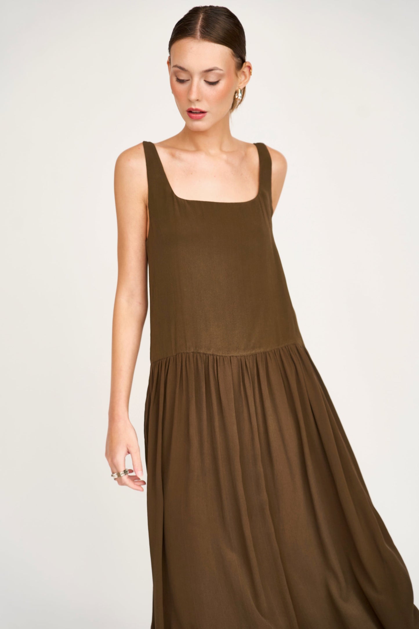 Brown silk midi dress on a hanger in store