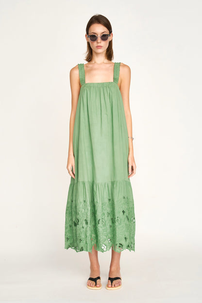 Green eyelet dress on a hanger in store
