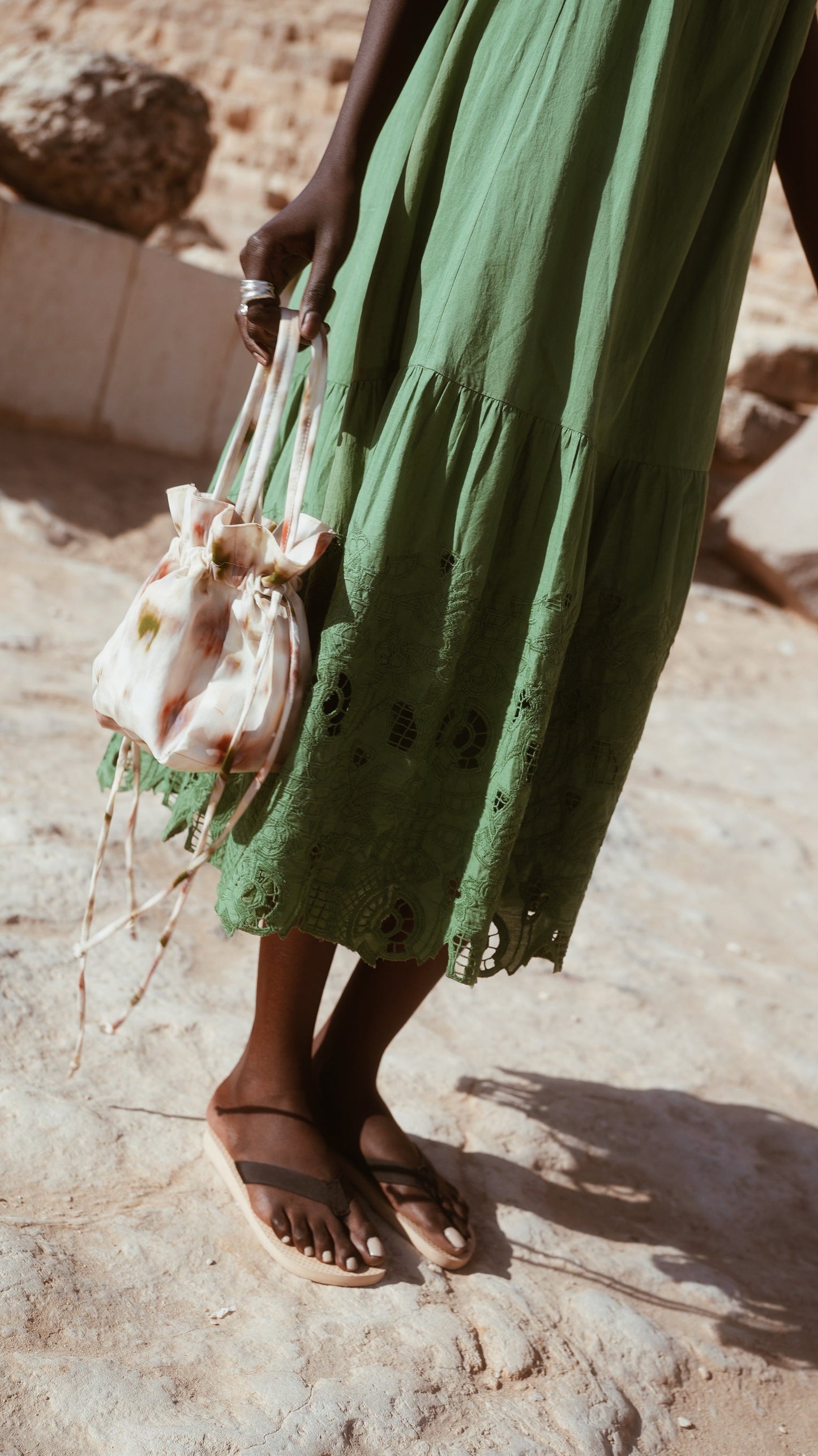 Green eyelet dress on a hanger in store