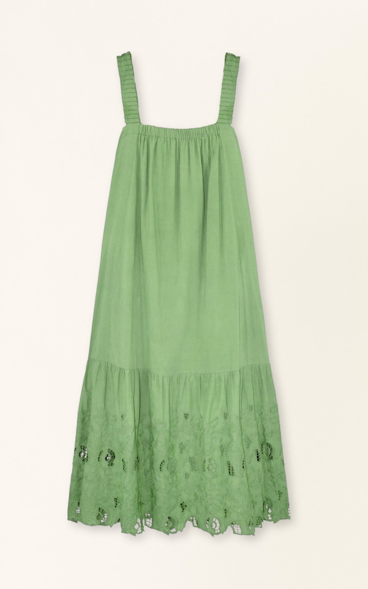 Green eyelet dress on a hanger in store