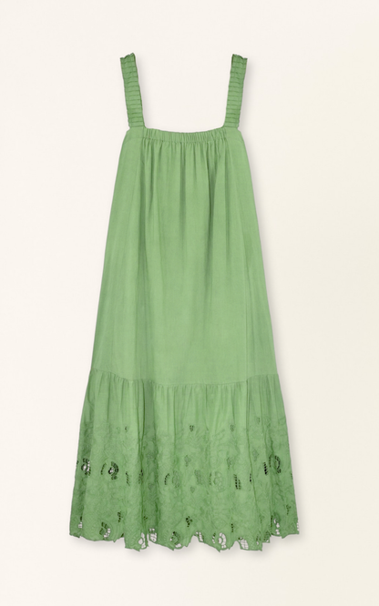 Green eyelet dress on a hanger in store
