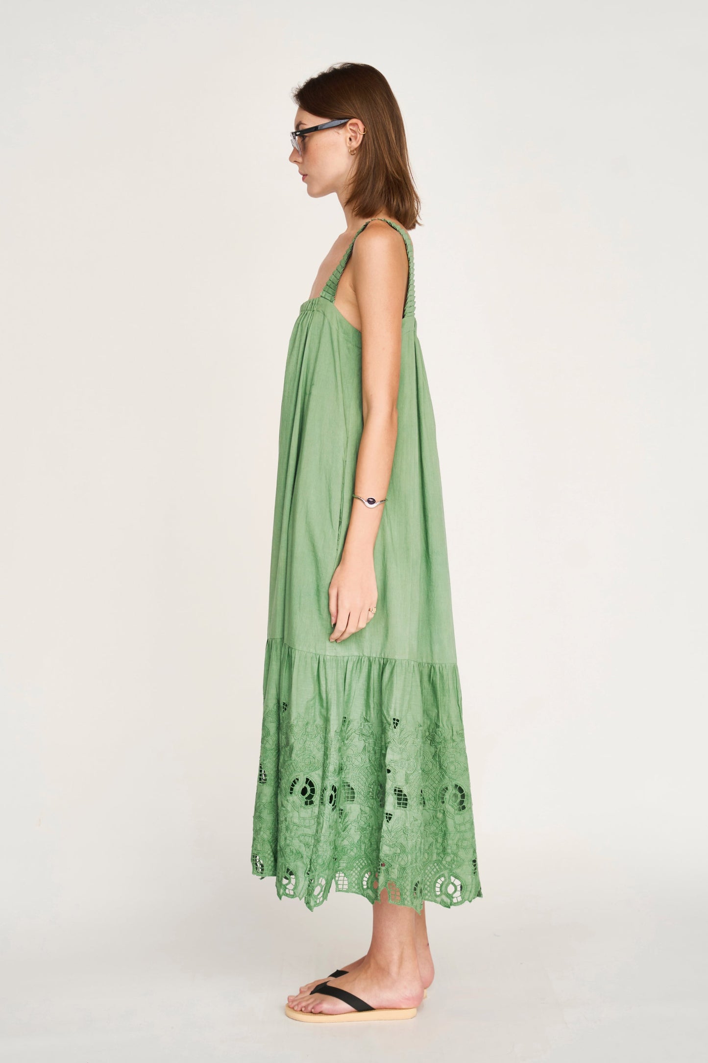 Green eyelet dress on a hanger in store