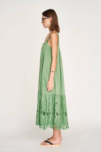 Green eyelet dress on a hanger in store