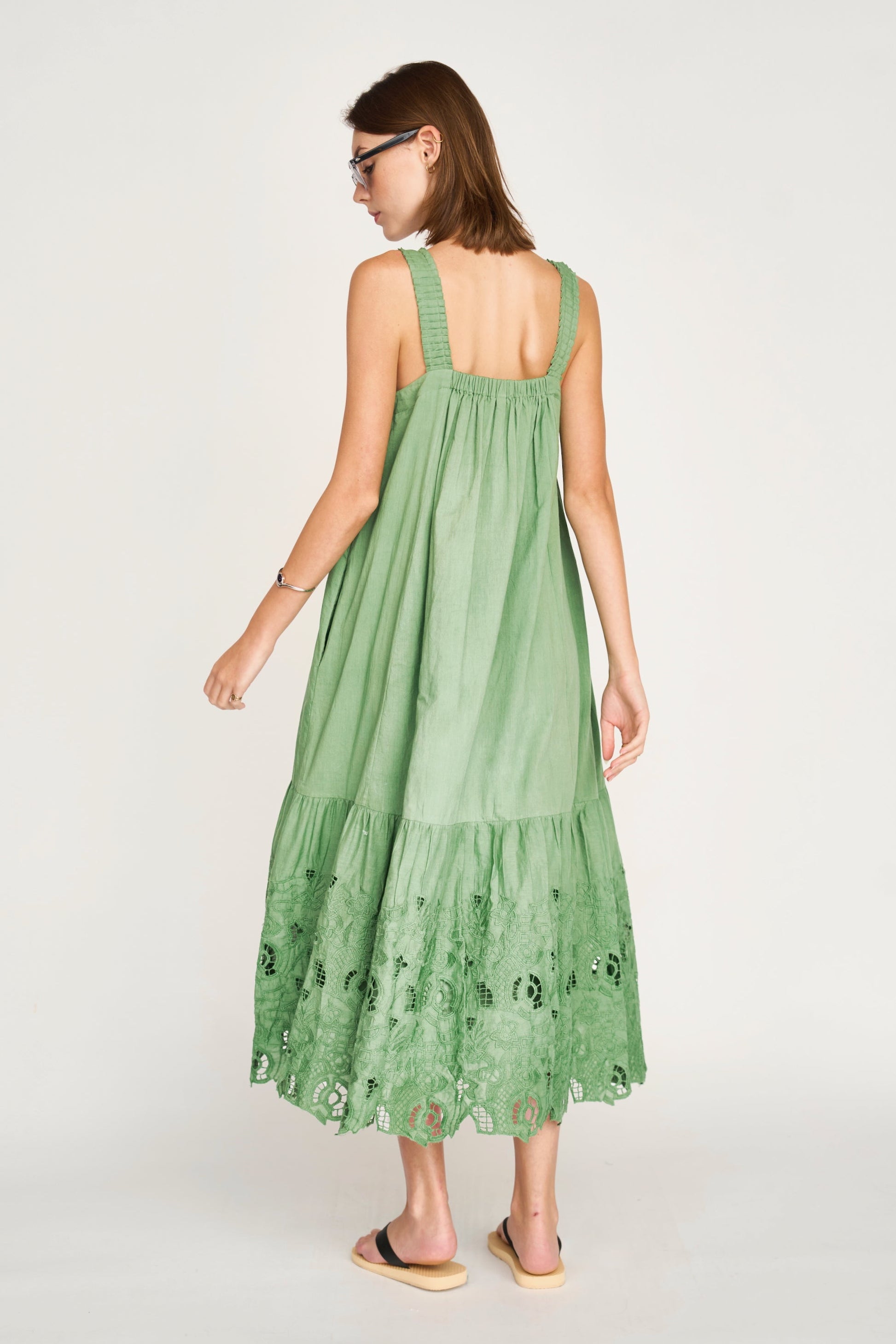 Green eyelet dress on a hanger in store