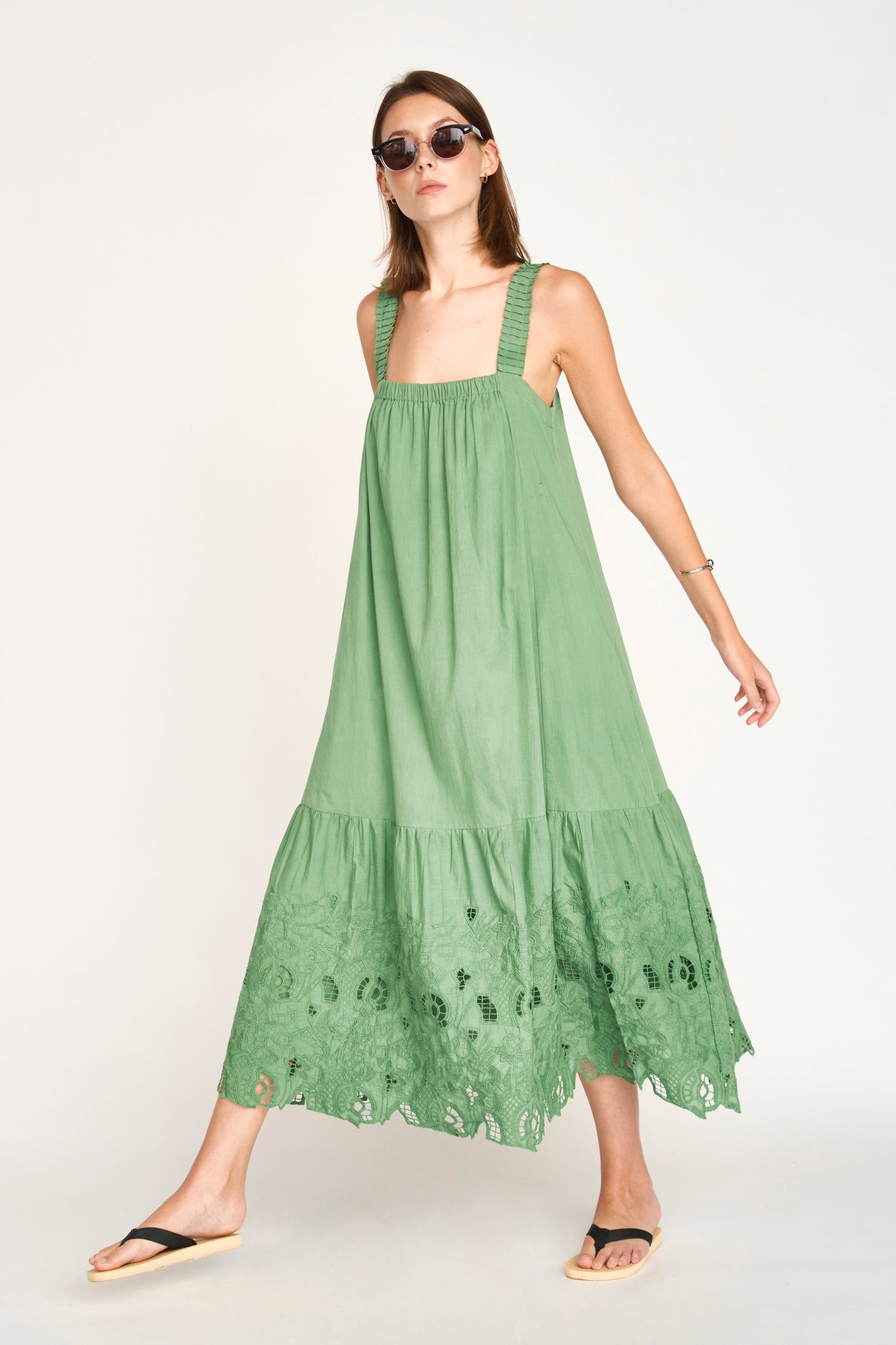 Green eyelet dress on a hanger in store