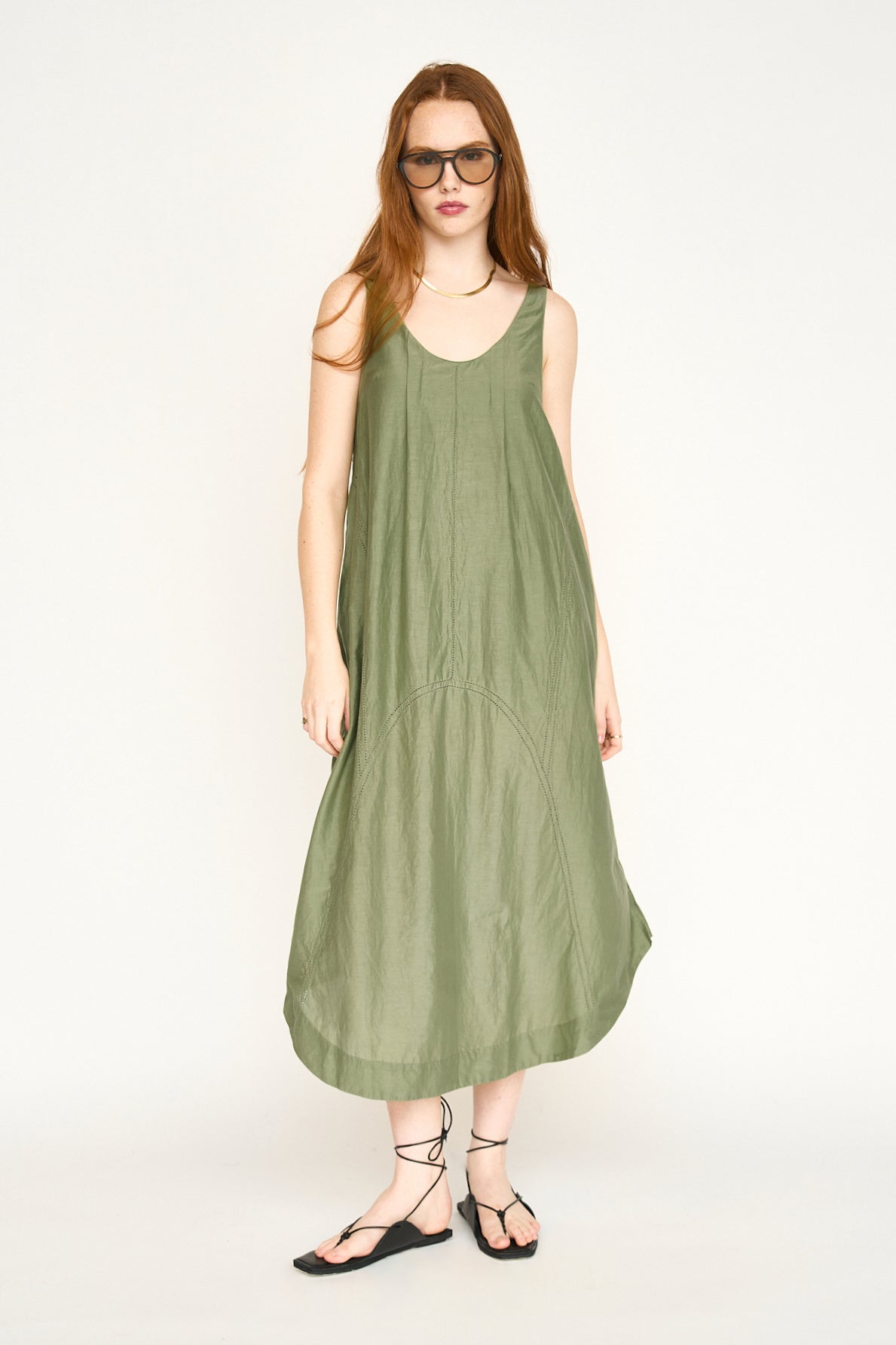 Green cotton dress on a hanger in store