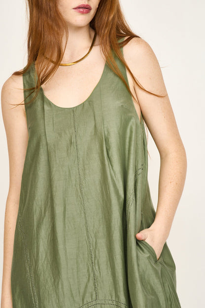 Green cotton dress on a hanger in store