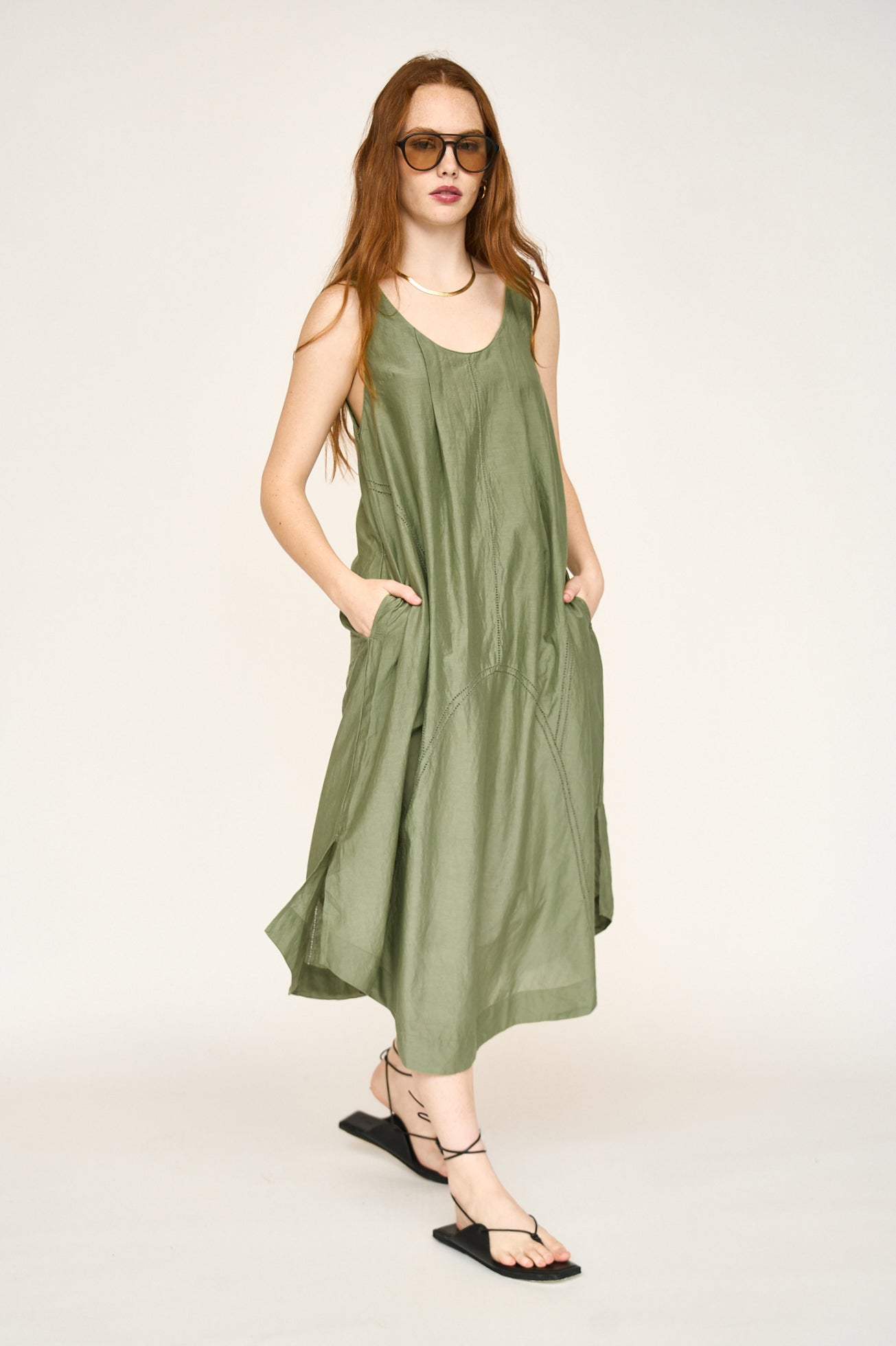 Green cotton dress on a hanger in store