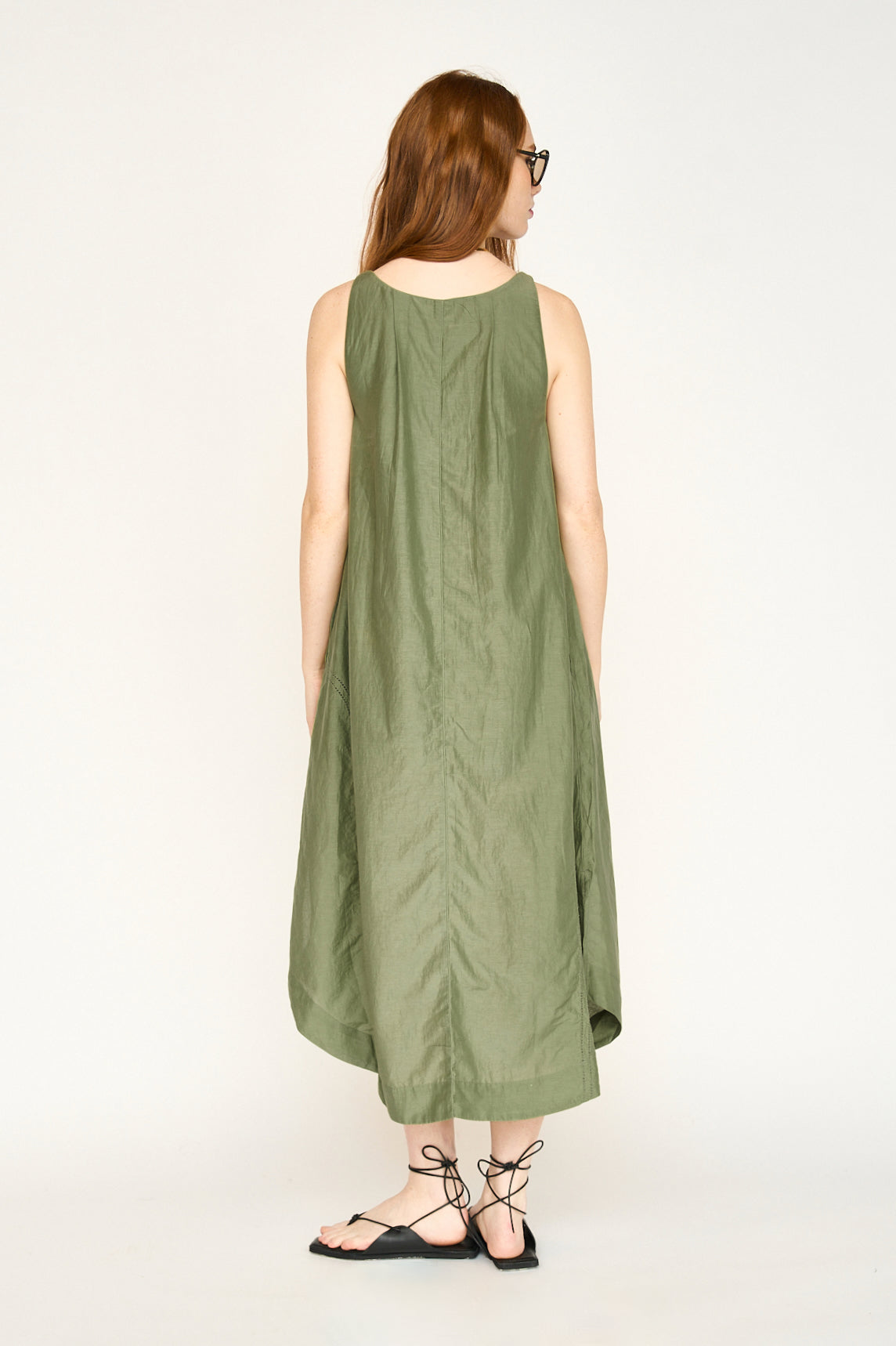 Green cotton dress on a hanger in store