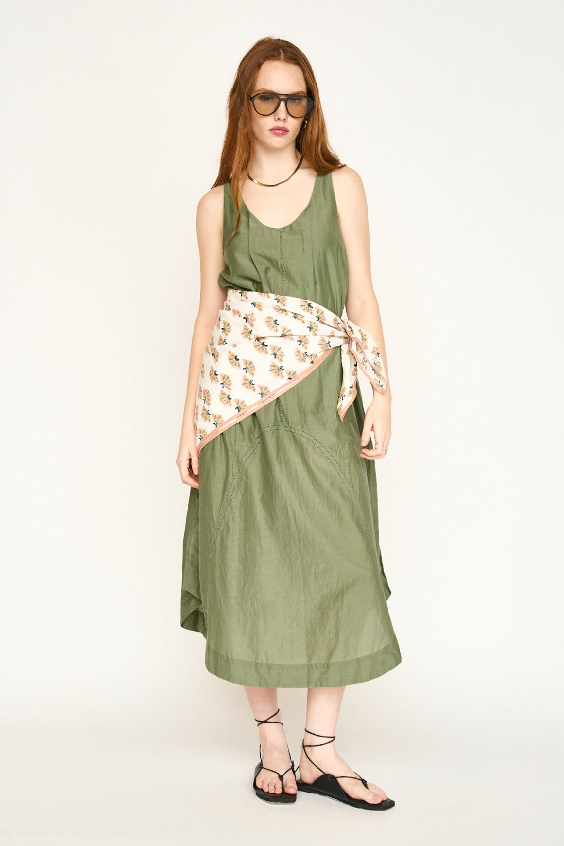 Green cotton dress on a hanger in store