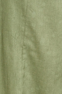 Green cotton dress on a hanger in store