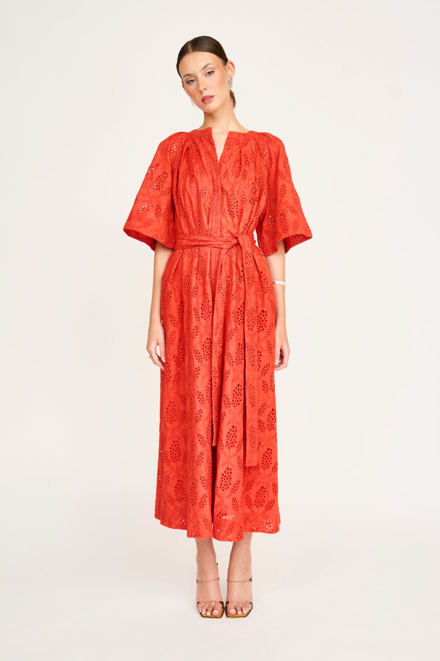 Red eyelet maxi dress on a hanger in store