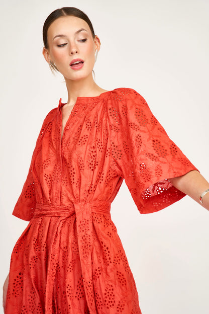 Red eyelet maxi dress on a hanger in store