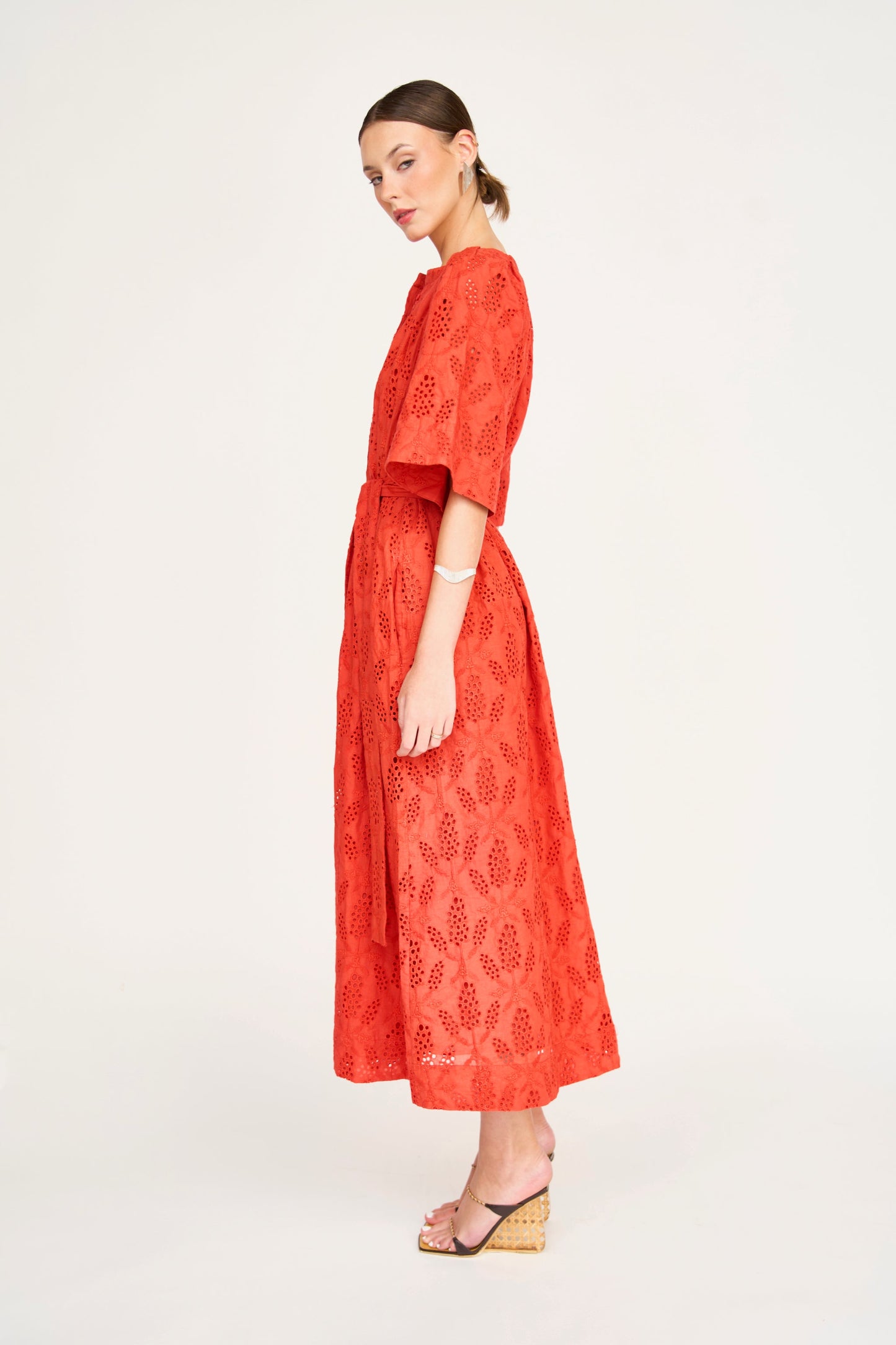 Red eyelet maxi dress on a hanger in store