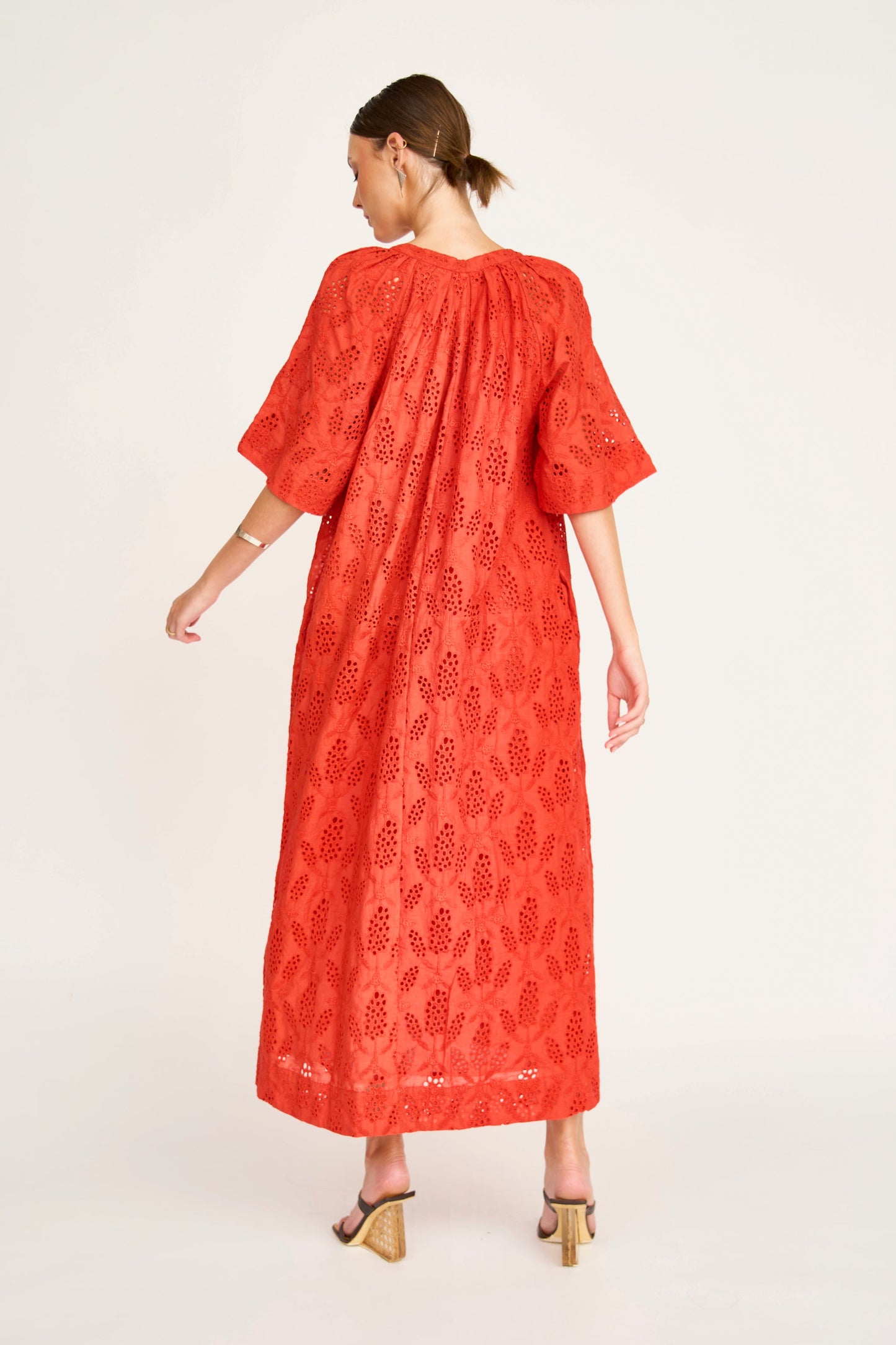 Red eyelet maxi dress on a hanger in store
