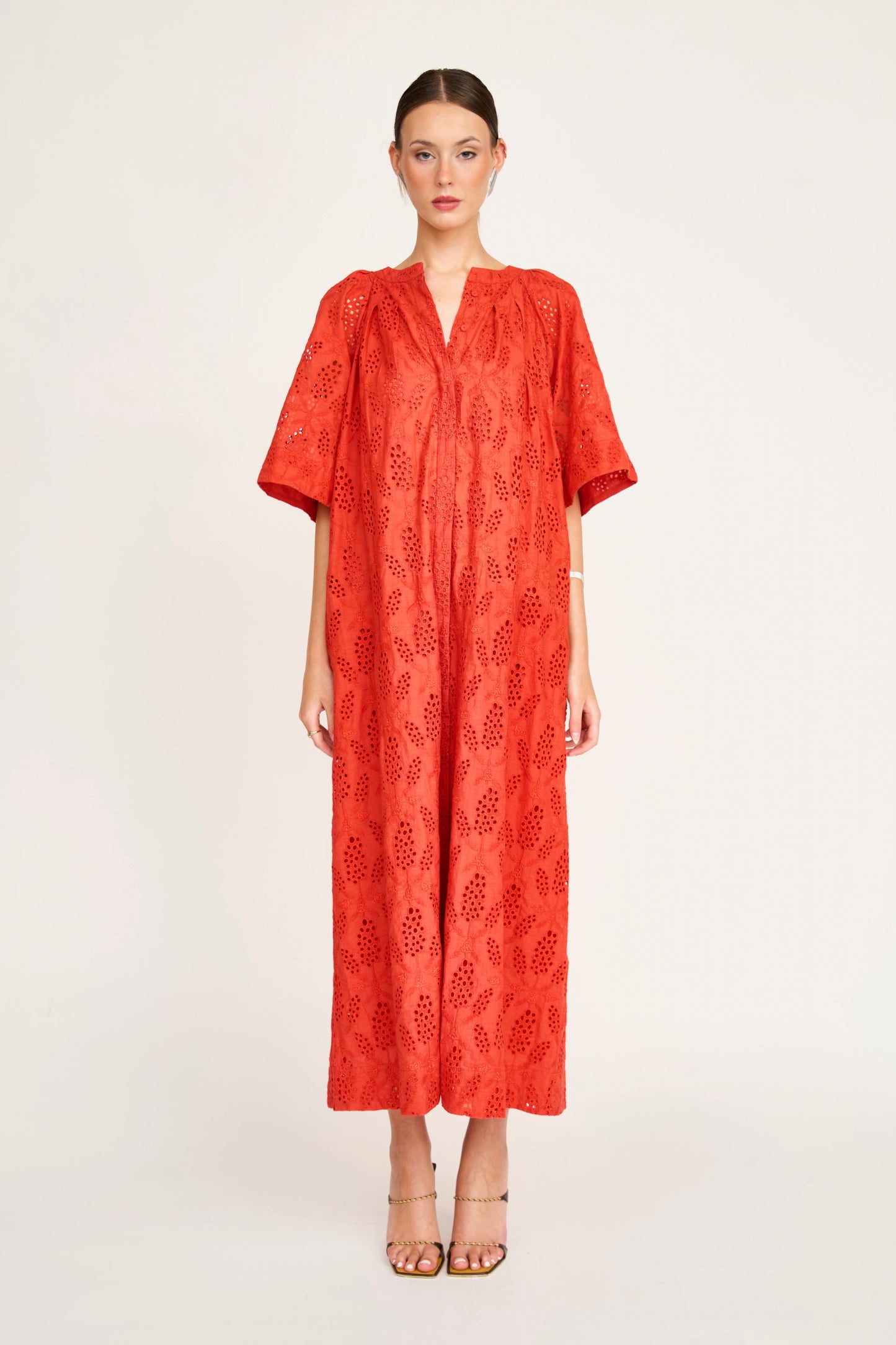Red eyelet maxi dress on a hanger in store