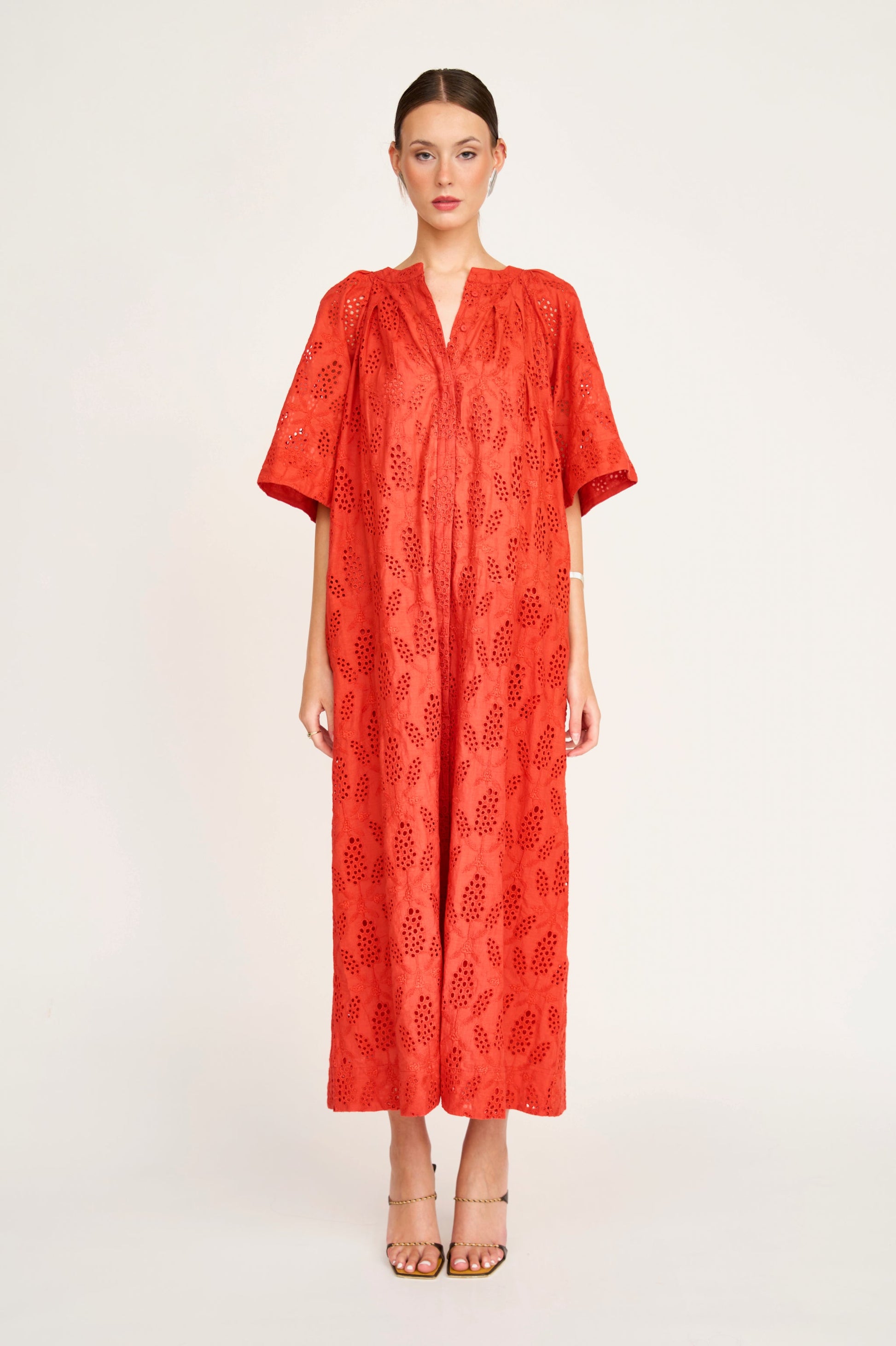 Red eyelet maxi dress on a hanger in store