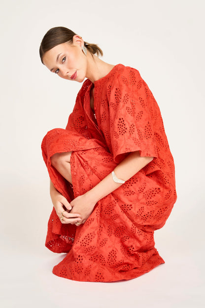 Red eyelet maxi dress on a hanger in store