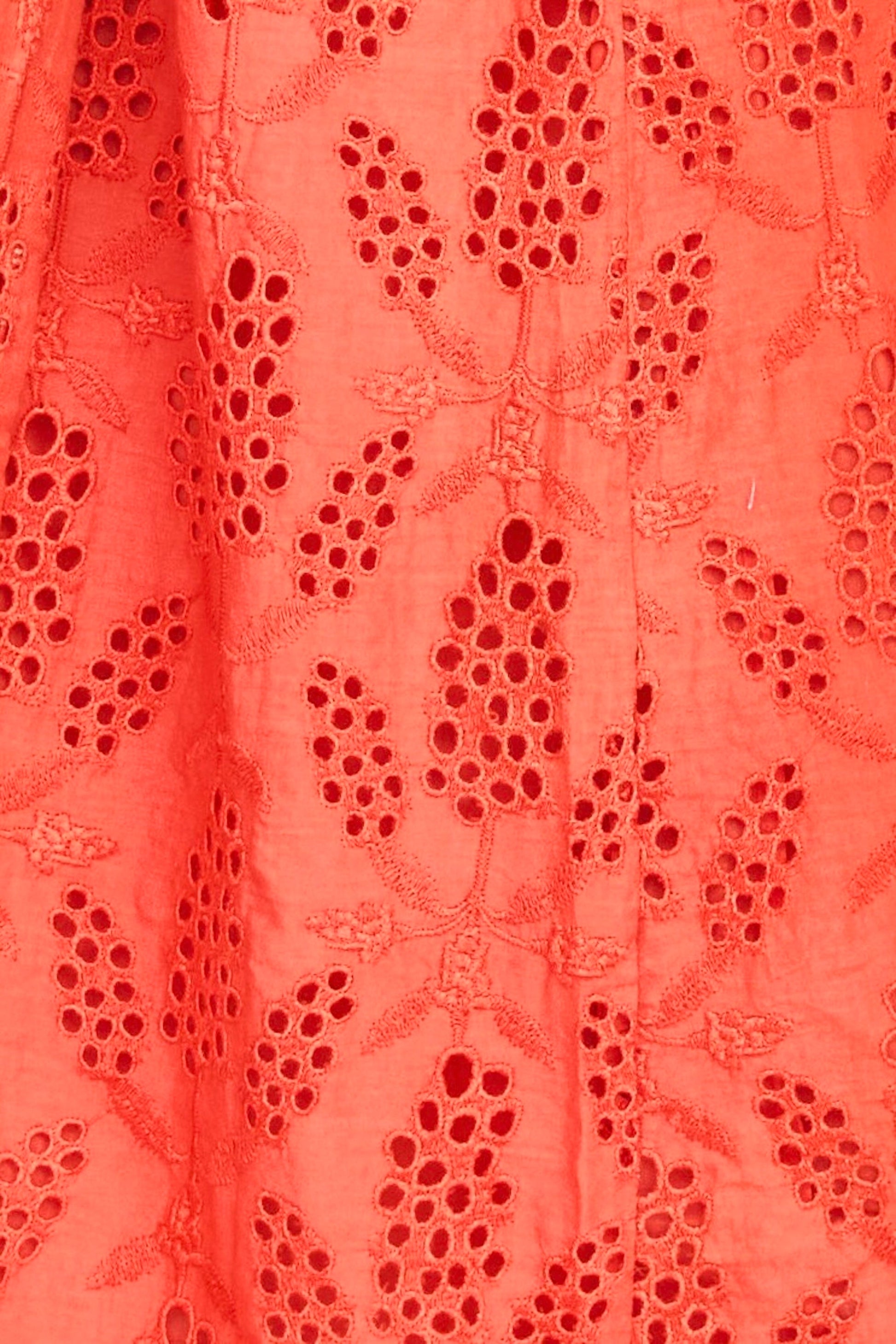 Red eyelet maxi dress on a hanger in store