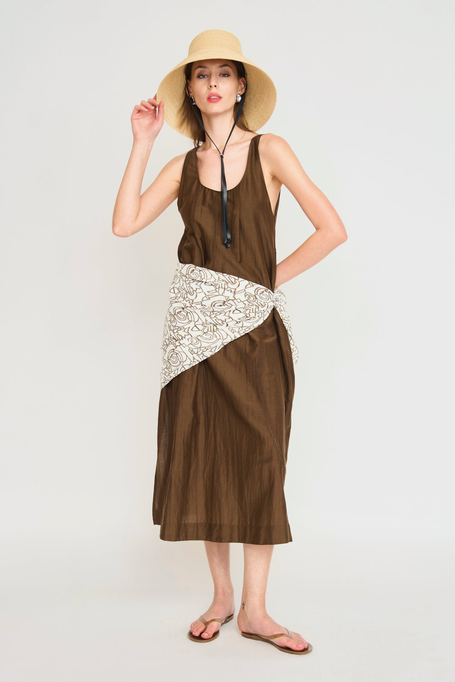 Brown cotton dress on a hanger in store