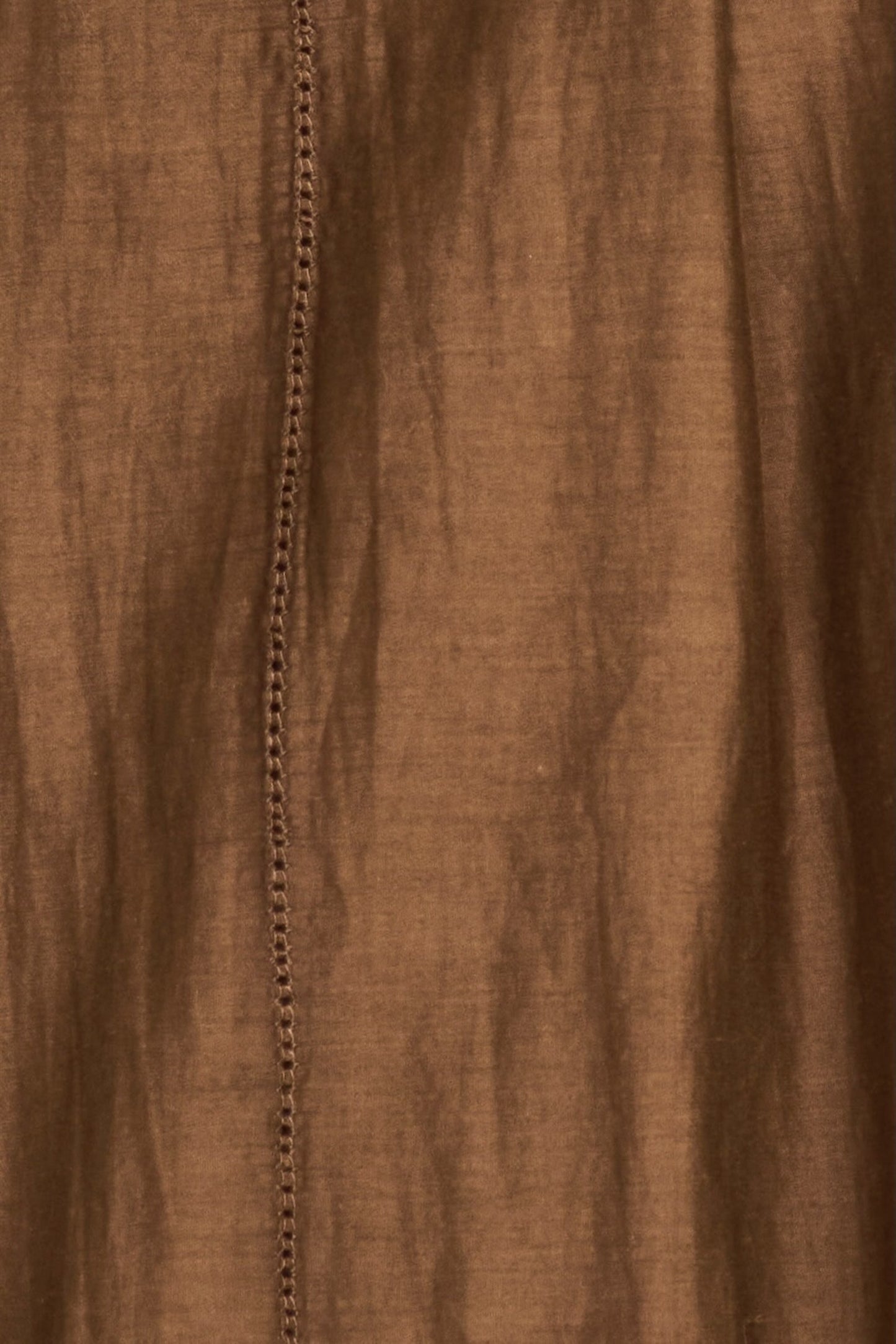 Brown cotton dress on a hanger in store