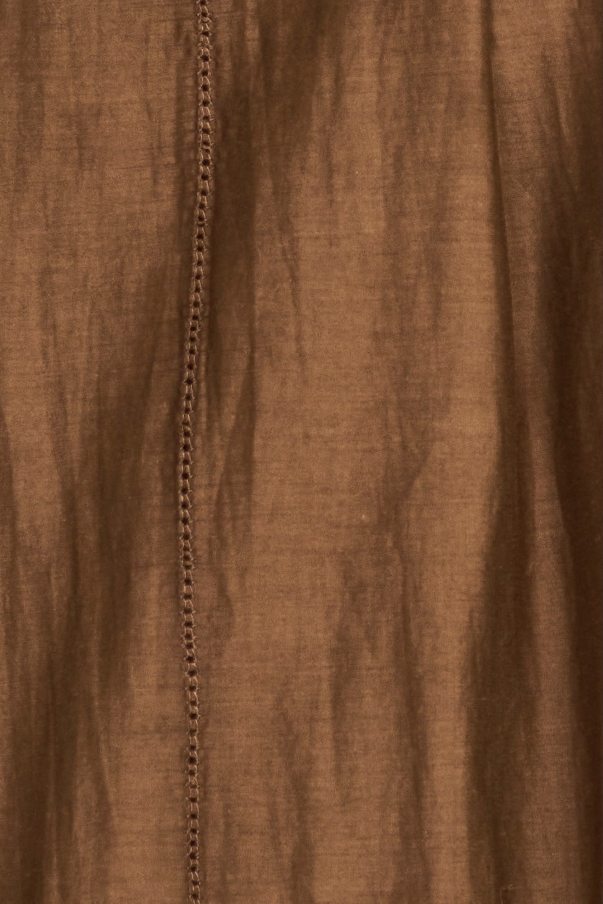 Brown cotton dress on a hanger in store