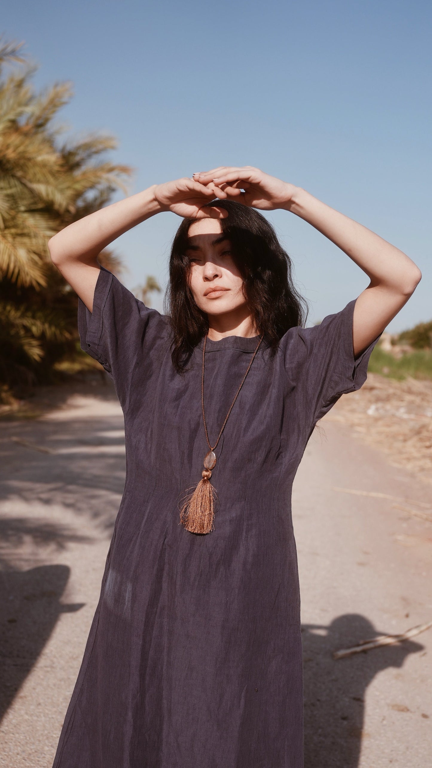 Blue linen maxi dress on a hanger in store
