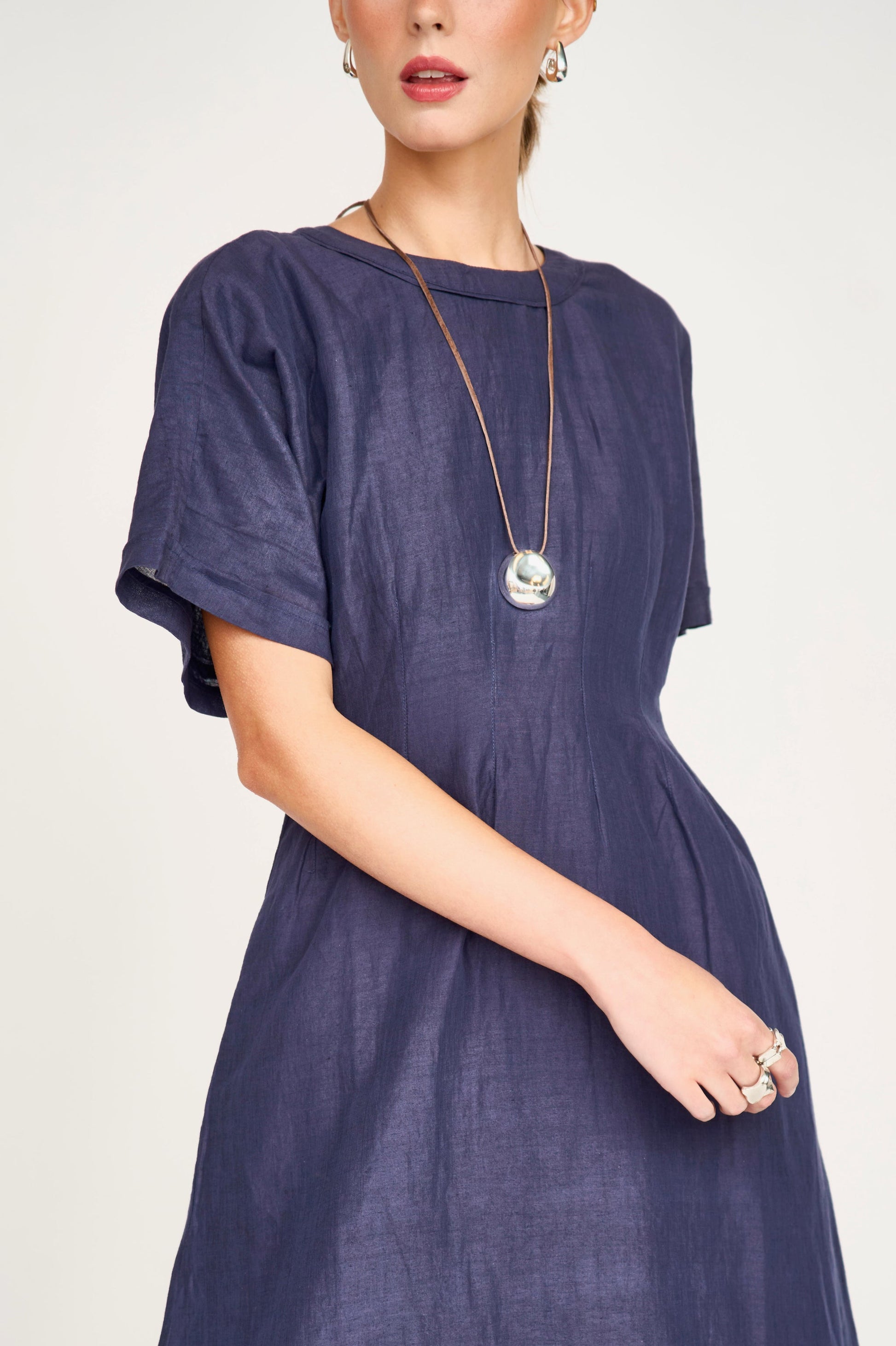 Blue linen maxi dress on a hanger in store