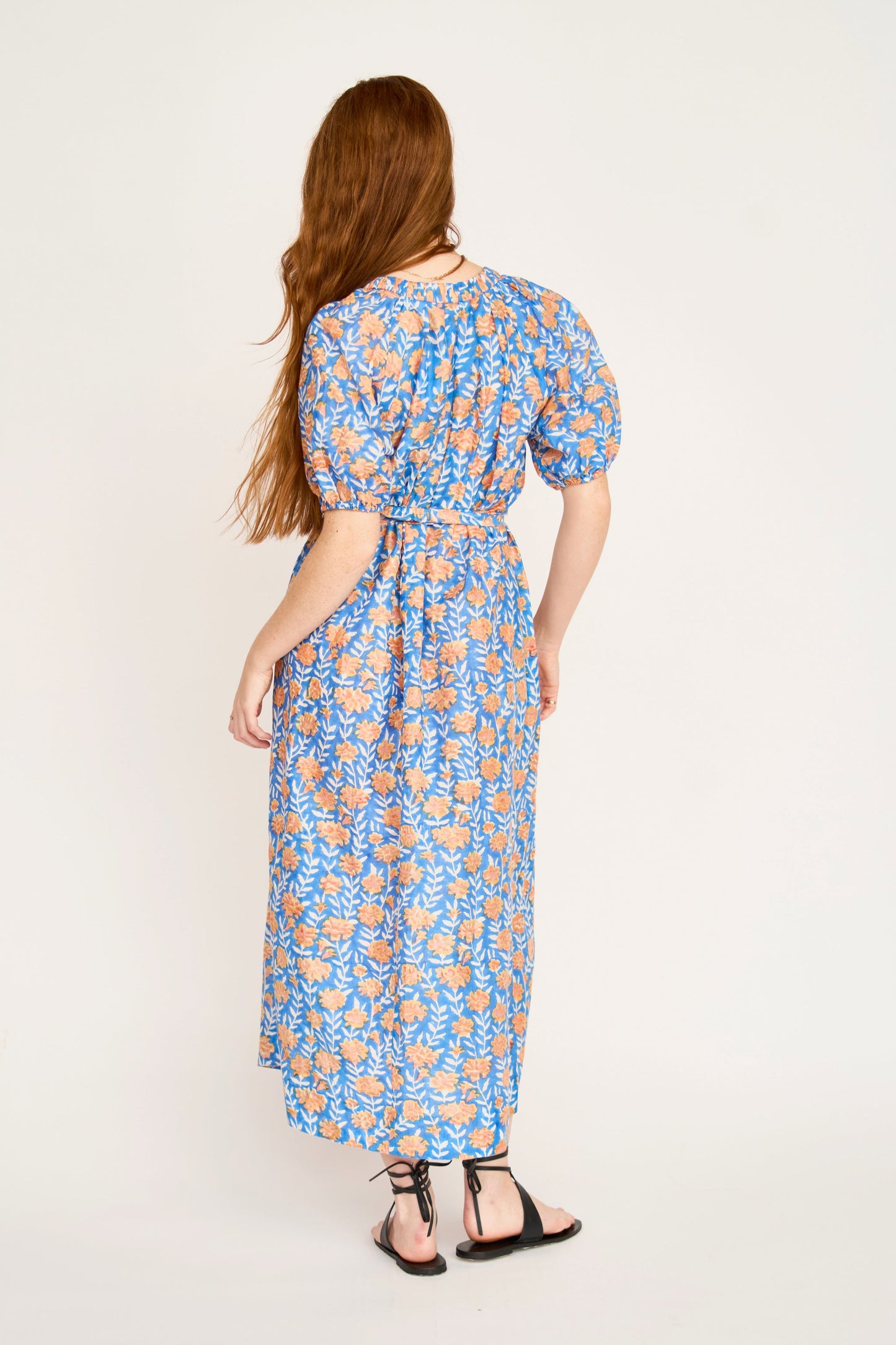 Pink cotton maxi dress on a hanger in store