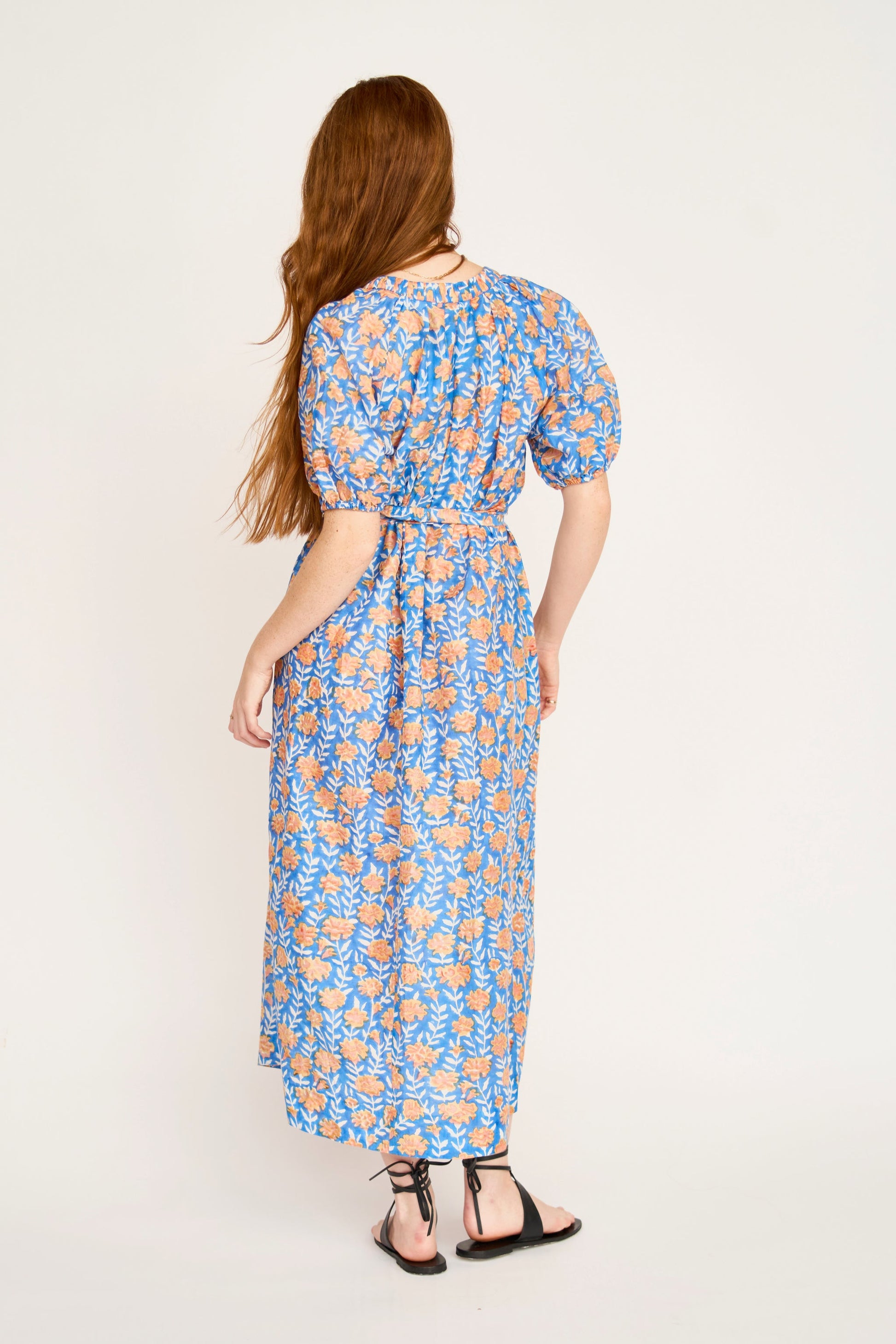 Pink cotton maxi dress on a hanger in store