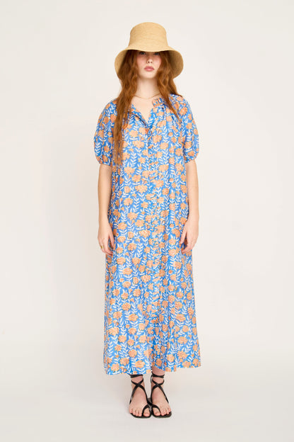 Pink cotton maxi dress on a hanger in store
