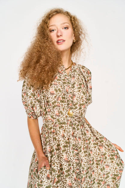 Pink cotton maxi dress on a hanger in store