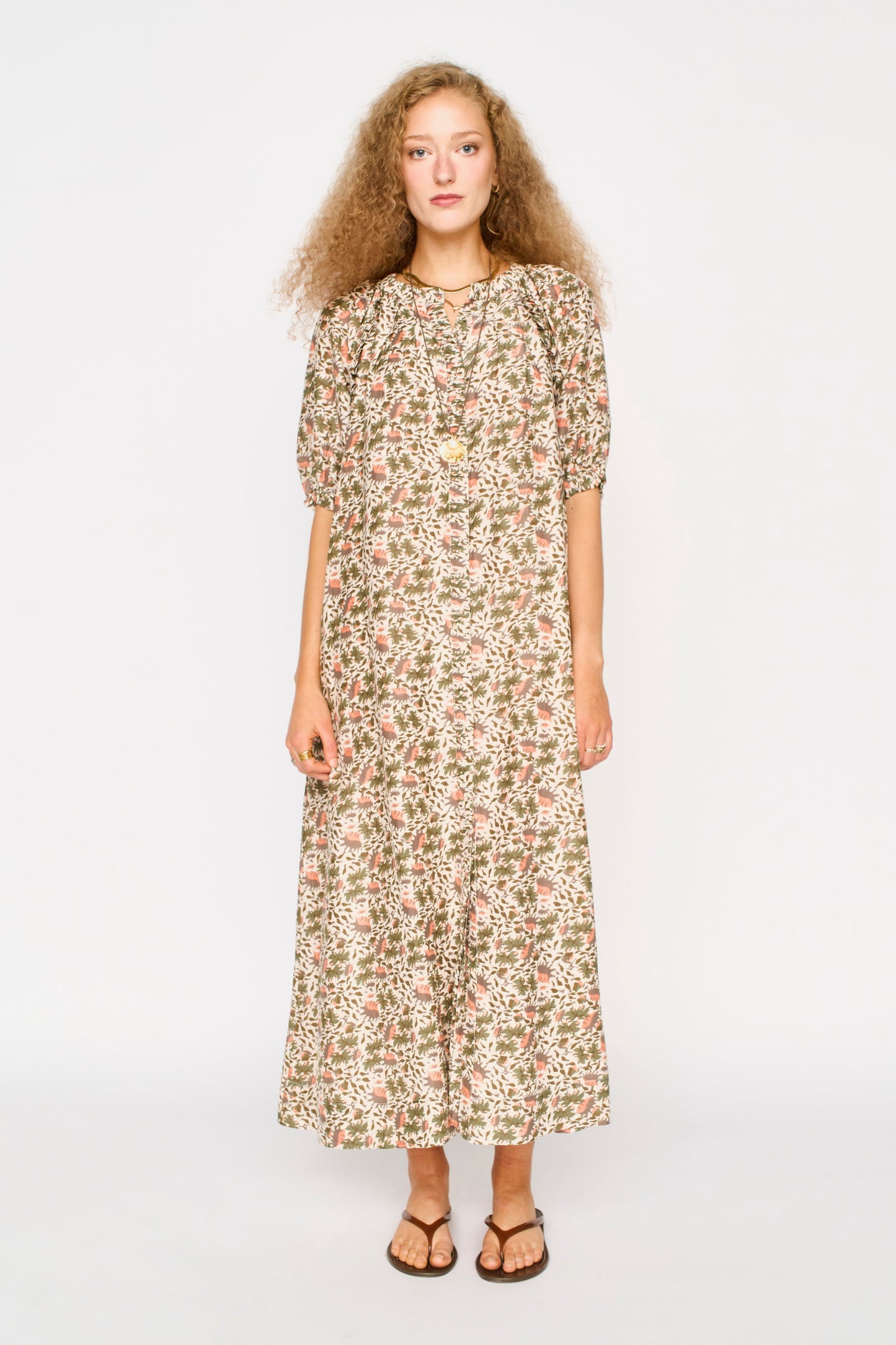 Pink cotton maxi dress on a hanger in store