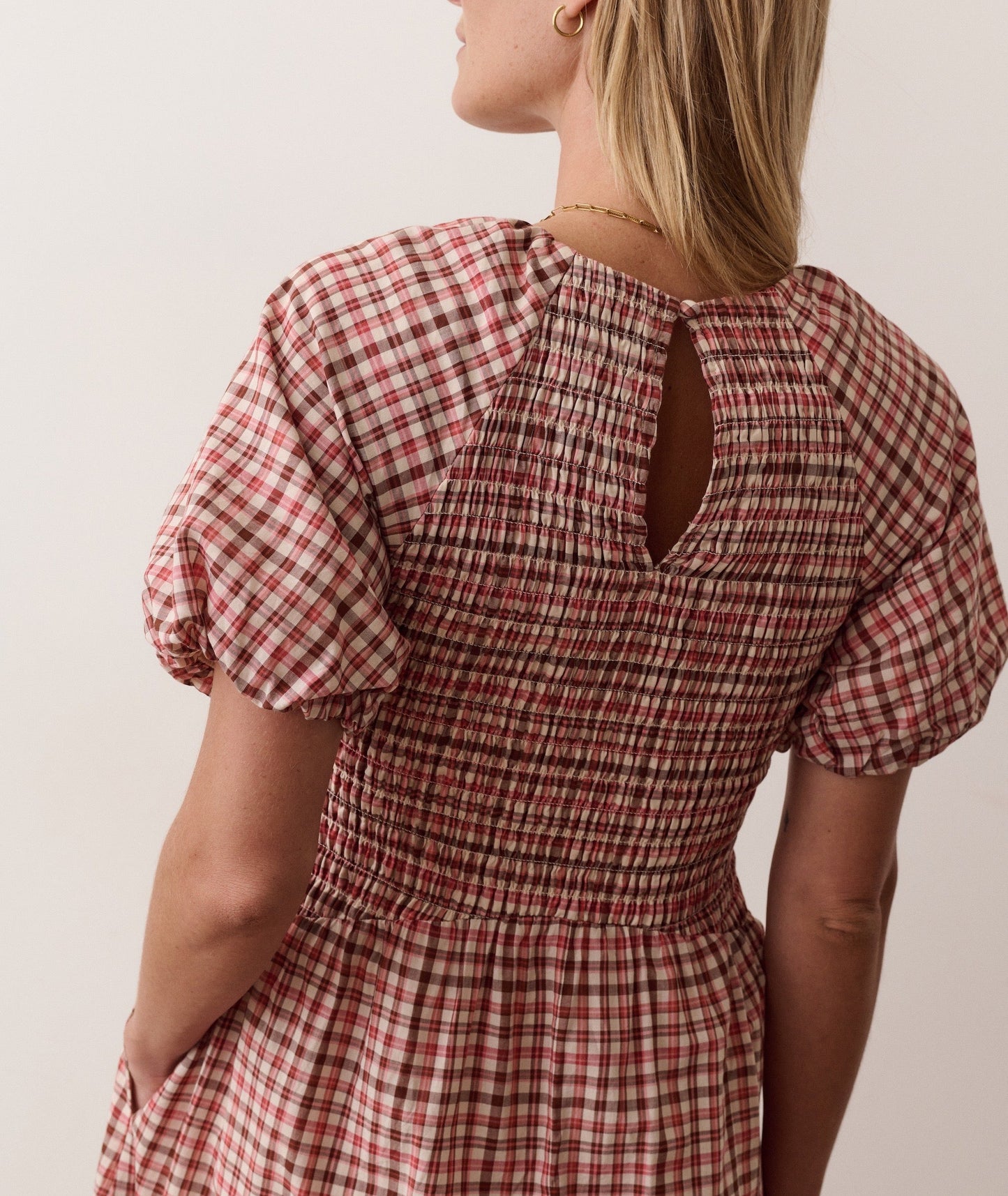 Blue smocked dress on a hanger in store