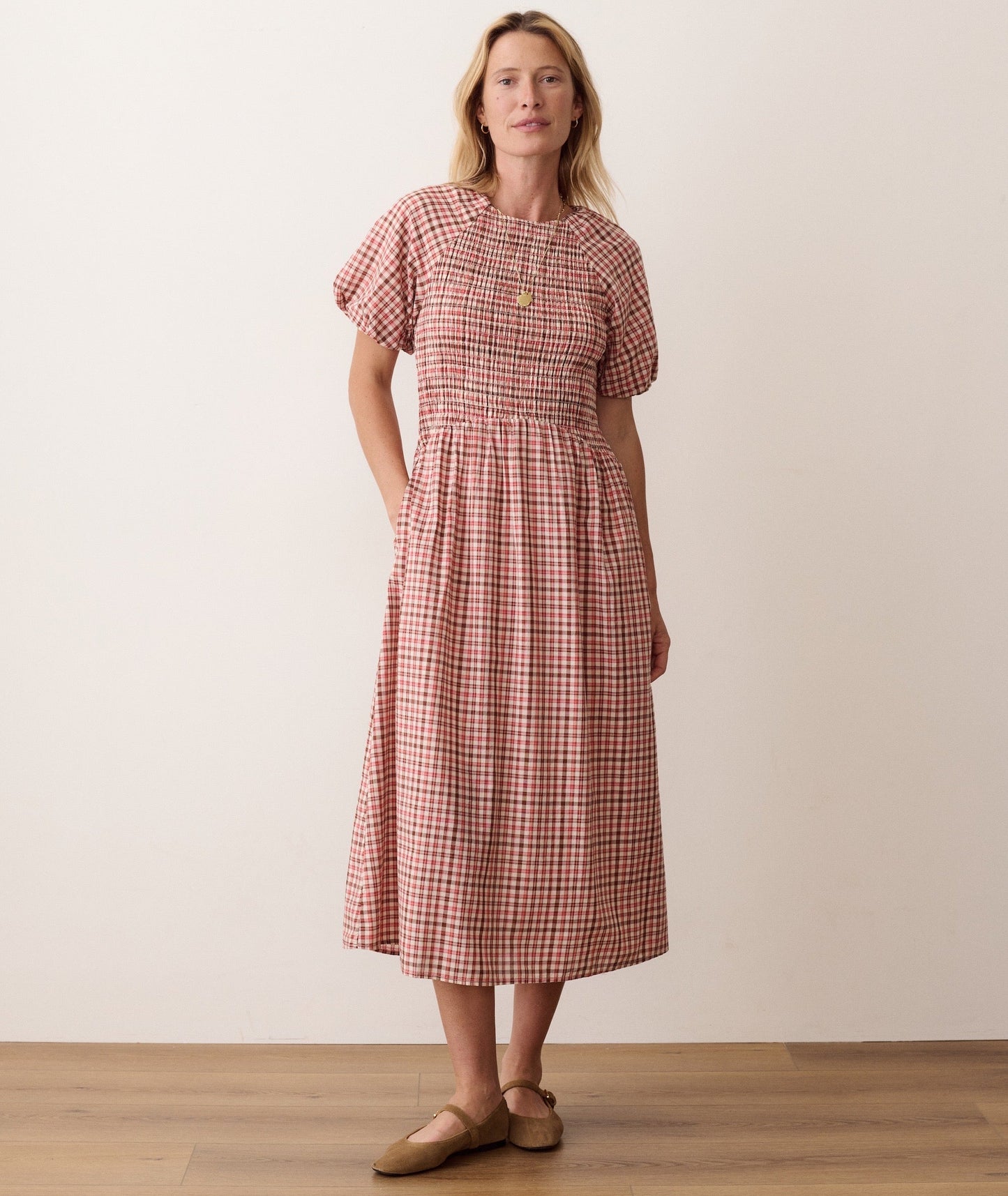 Blue smocked dress on a hanger in store