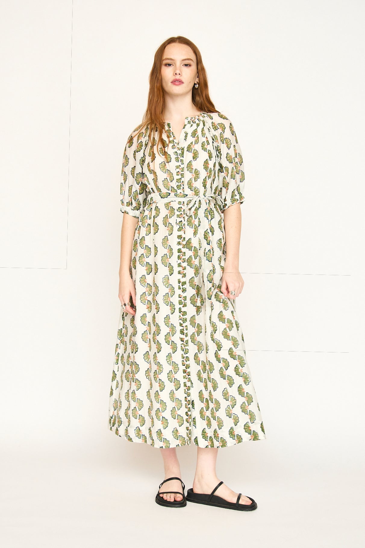 Green cotton maxi dress on a hanger in store