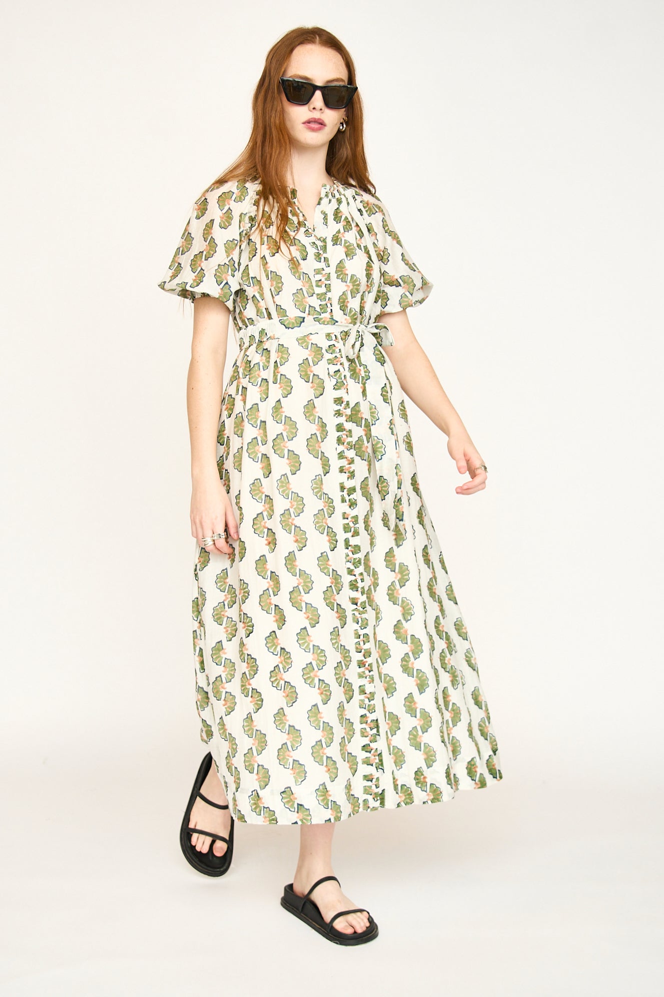 Green cotton maxi dress on a hanger in store