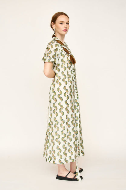 Green cotton maxi dress on a hanger in store