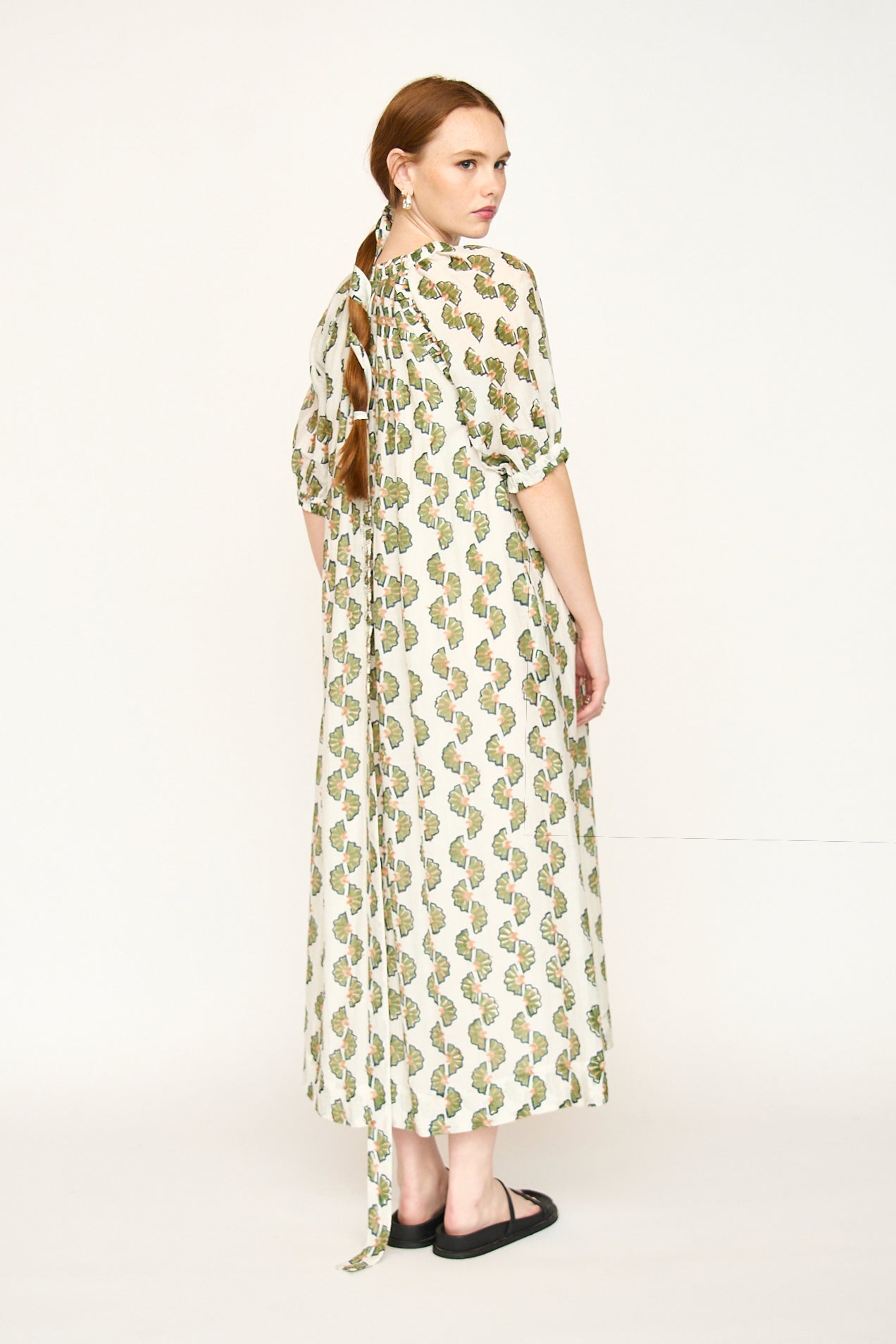 Green cotton maxi dress on a hanger in store