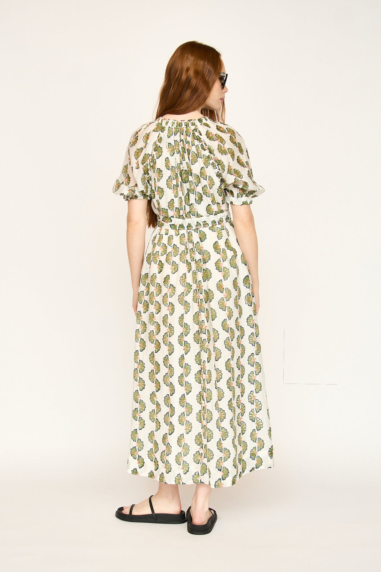 Green cotton maxi dress on a hanger in store